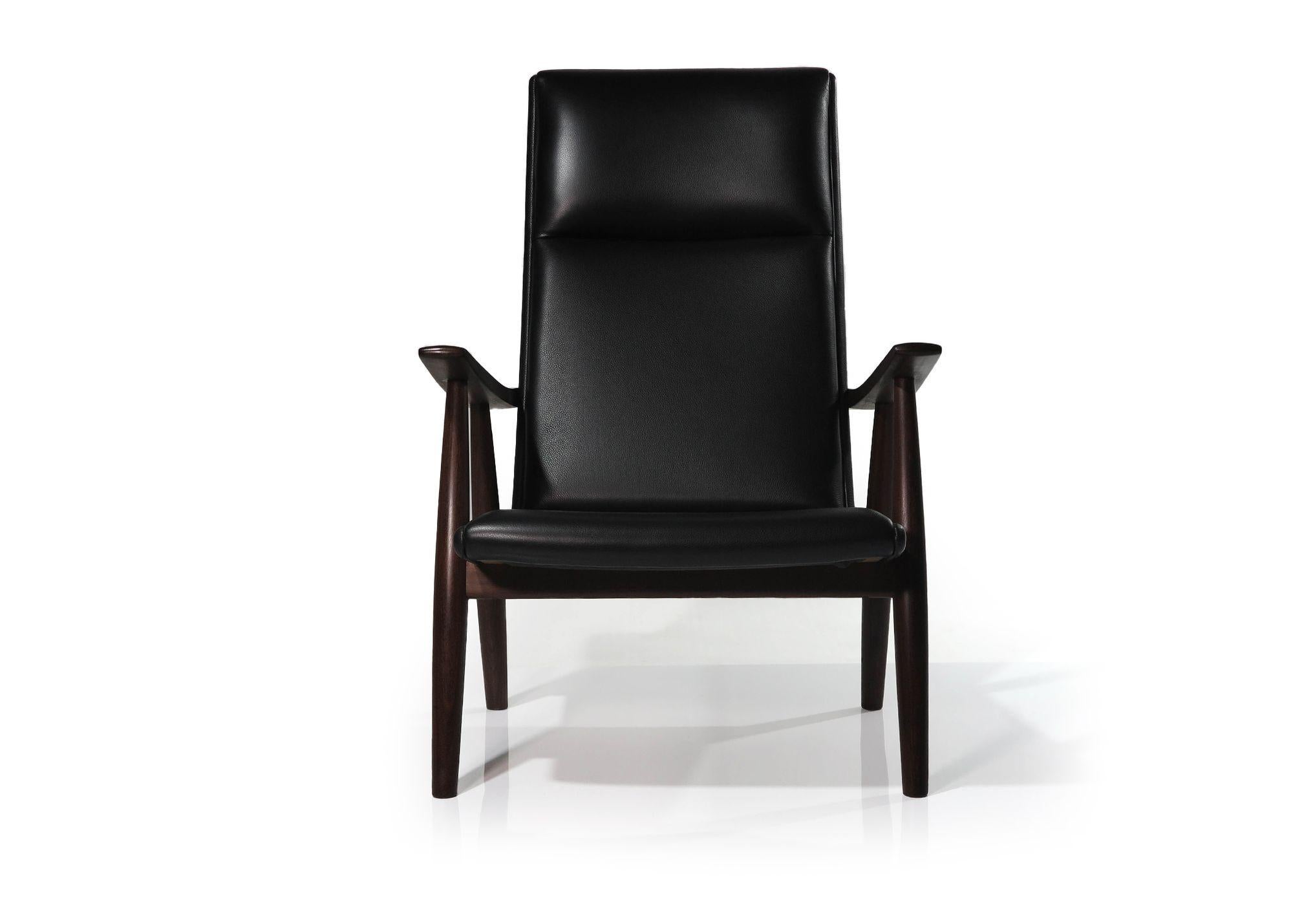 Danish high back lounge chair designed by Hans Wegner for Getama, 1955, Denmark. The chair is crafted of dark teak with sloping arms, and newly upholstered in a fine black leather. 
Measurements W 26.50'' x D 32.50'' x H 40''
Seat Height 15''.
