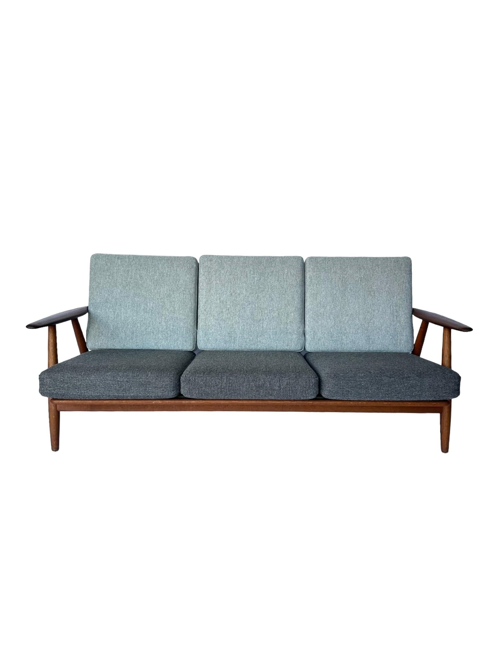 Designed by Hans Wegner for Getama in 1955, the 240 “Cigar” sofa features classic Danish minimalist elegance in craftsmanship and manufacture. Iconic sculpted arms and legs give the design its Cigar moniker. Built by Getama in Denmark and stamped