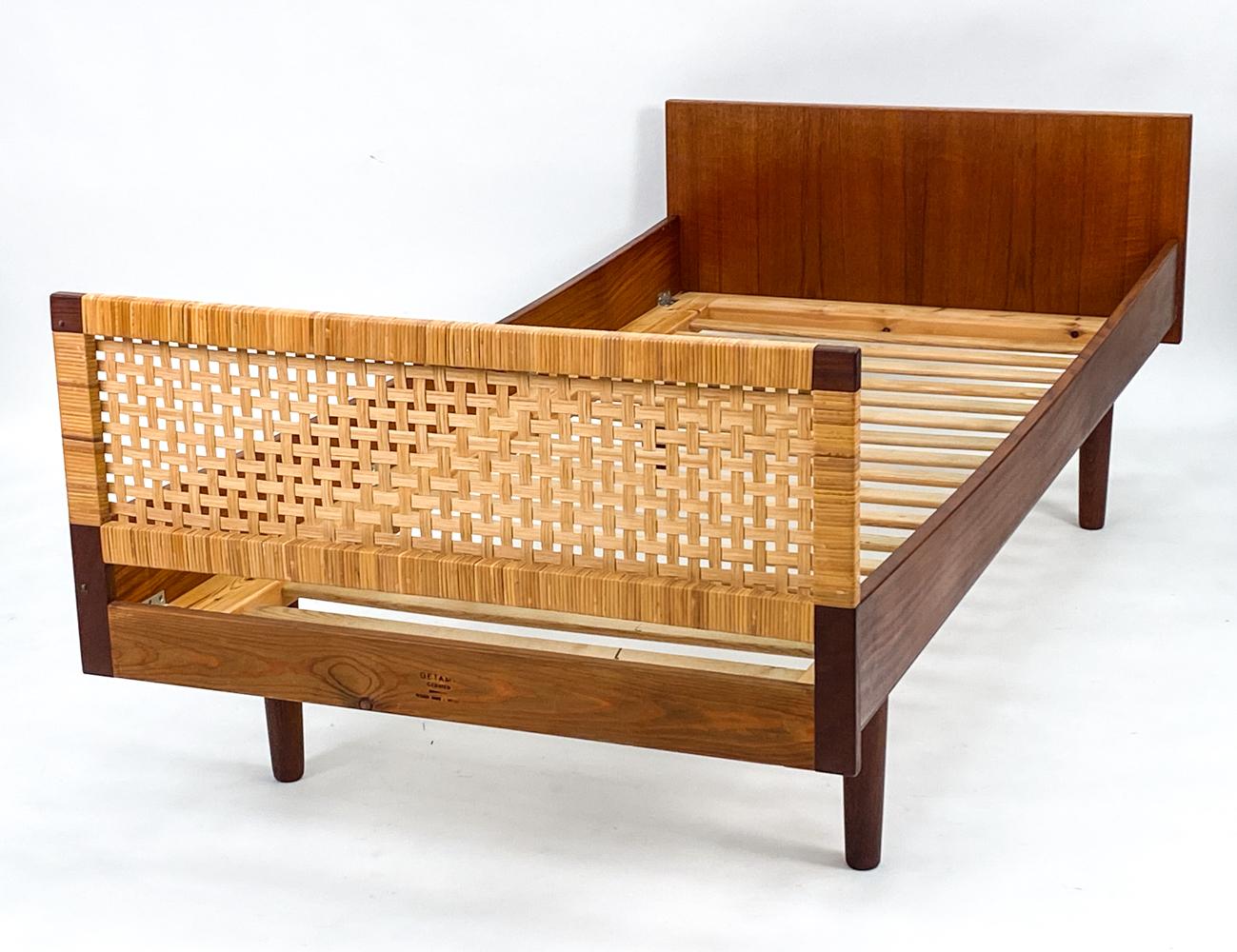 A fabulous Danish mid-century daybed in teak with a caned headboard or footboard, designed by Hans Wegner for GETAMA. With GETAMA stamp to one rail. This fun piece features slat supports for a custom cushion to be used as a daybed or for a custom