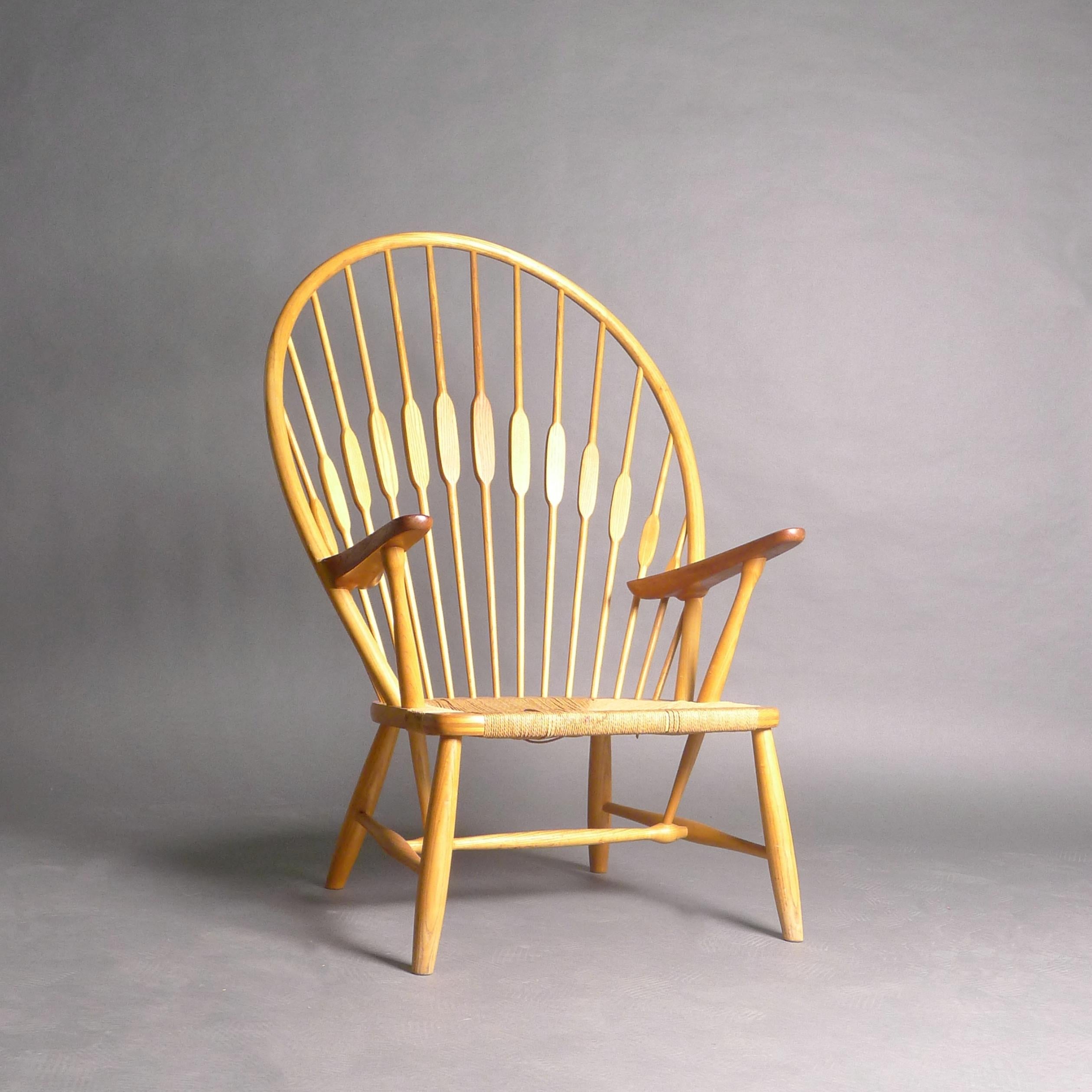 Hans J Wegner, Peacock Chair, model JH-550, designed in 1947 and manufactured by Johannes Hansen in ash and teak, the seat woven in papercord.  This example believed to date from late 1960s-1970.

Branded manufacturer's mark to underside ‘Johannes