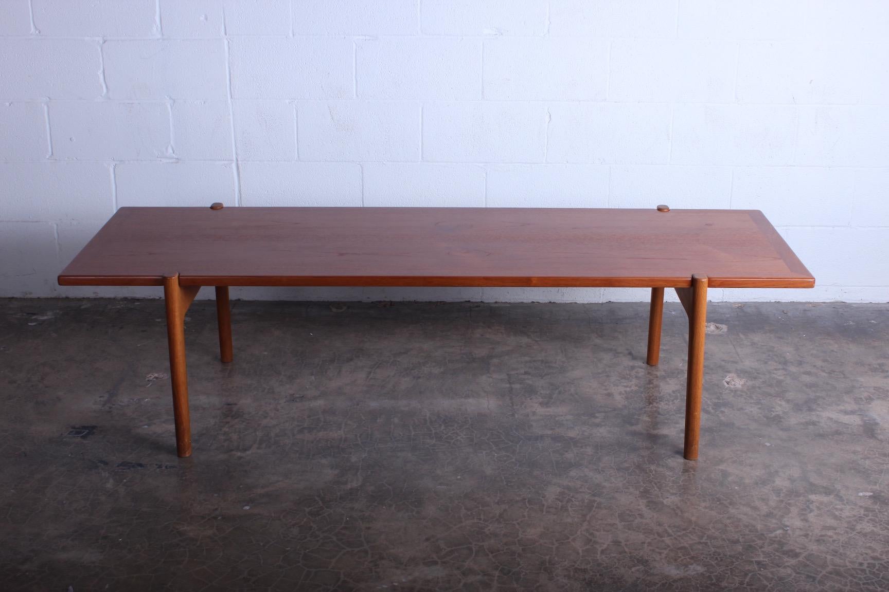 Hans Wegner for Johannes Hansen, Denmark, 1950s. A reverse topped coffee table with oak frame, stamped by maker, and a top of teak on one side and black formica on the other.