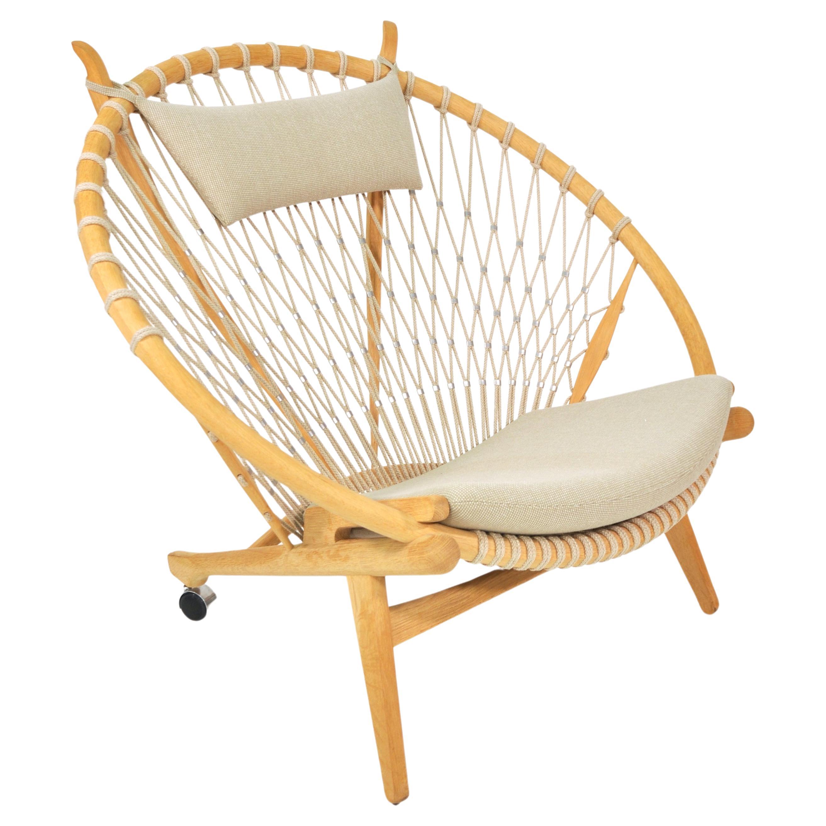 Stunning Scandinavian Mid-Century Modern easy chair designed by the Danish legend Hans Wegner in 1949, and put in production in 1986 by PP Mobler. The made to order hoop lounge chair features a net of pleated flag line with stainless steel clips, a