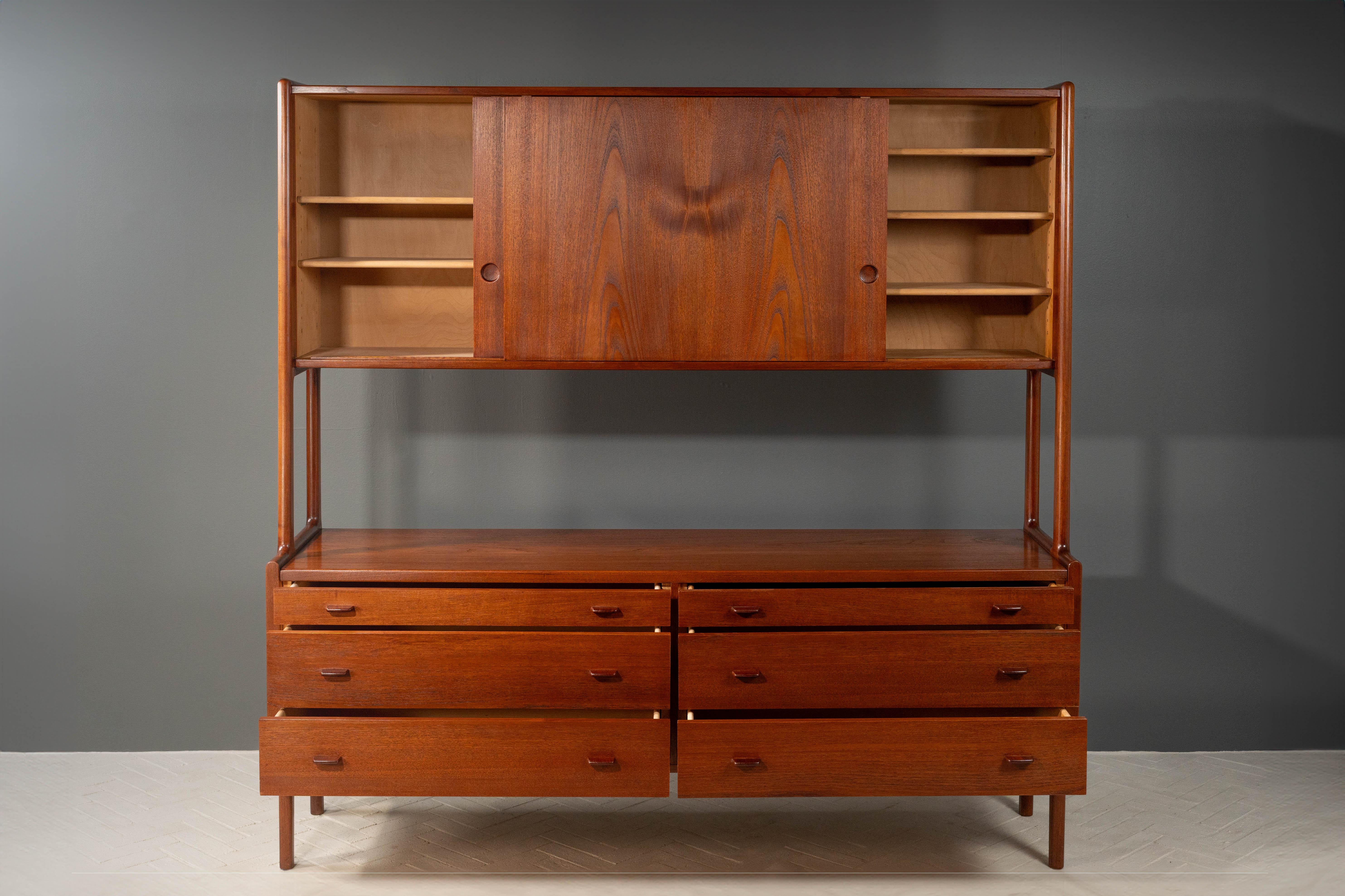 Denmark, ca. 1950s. A stunning Model RY20 sideboard by Hans Wegner for Ry Møbler. Features teak construction with contrasting birch interiors. Lower portion consists of six wide drawers ideal for holding linens and serving items - each finished with