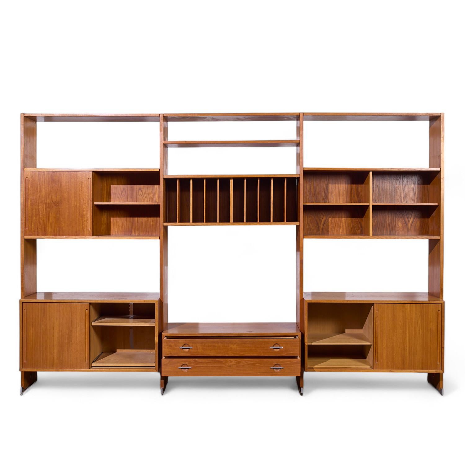 Hans Wegner for Ry Mobler RY-100 Mid Century Danish Teak 3 Bay Modular Wall Unit

This wall unit measures: 122.5 wide x 19.25 deep x 81.5 inches high

All pieces of furniture can be had in what we call restored vintage condition. That means the