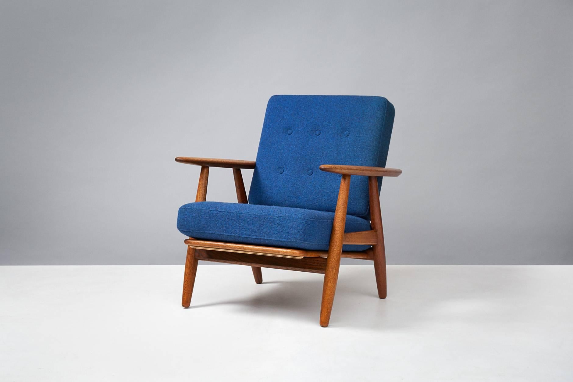 Hans J. Wegner

GE-240 'Cigar' chair, 1955

Produced by Getama, Gedsted, Denmark. Oak frame with original sprung cushions reupholstered in blue Kvadrat Hallingdal wool fabric. Maker's brand under seat.