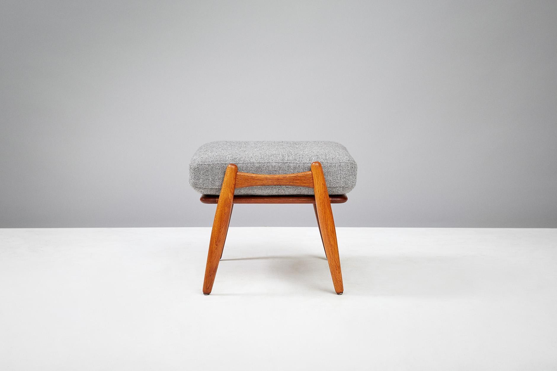 Hans J. Wegner
GE-240 cigar stool, circa 1950s.

Oak ottoman produced by Getama, Denmark to compliment the GE-240 and GE-260 lounge chairs. Original sprung cushion has been recovered in grey Kvadrat wool fabric.