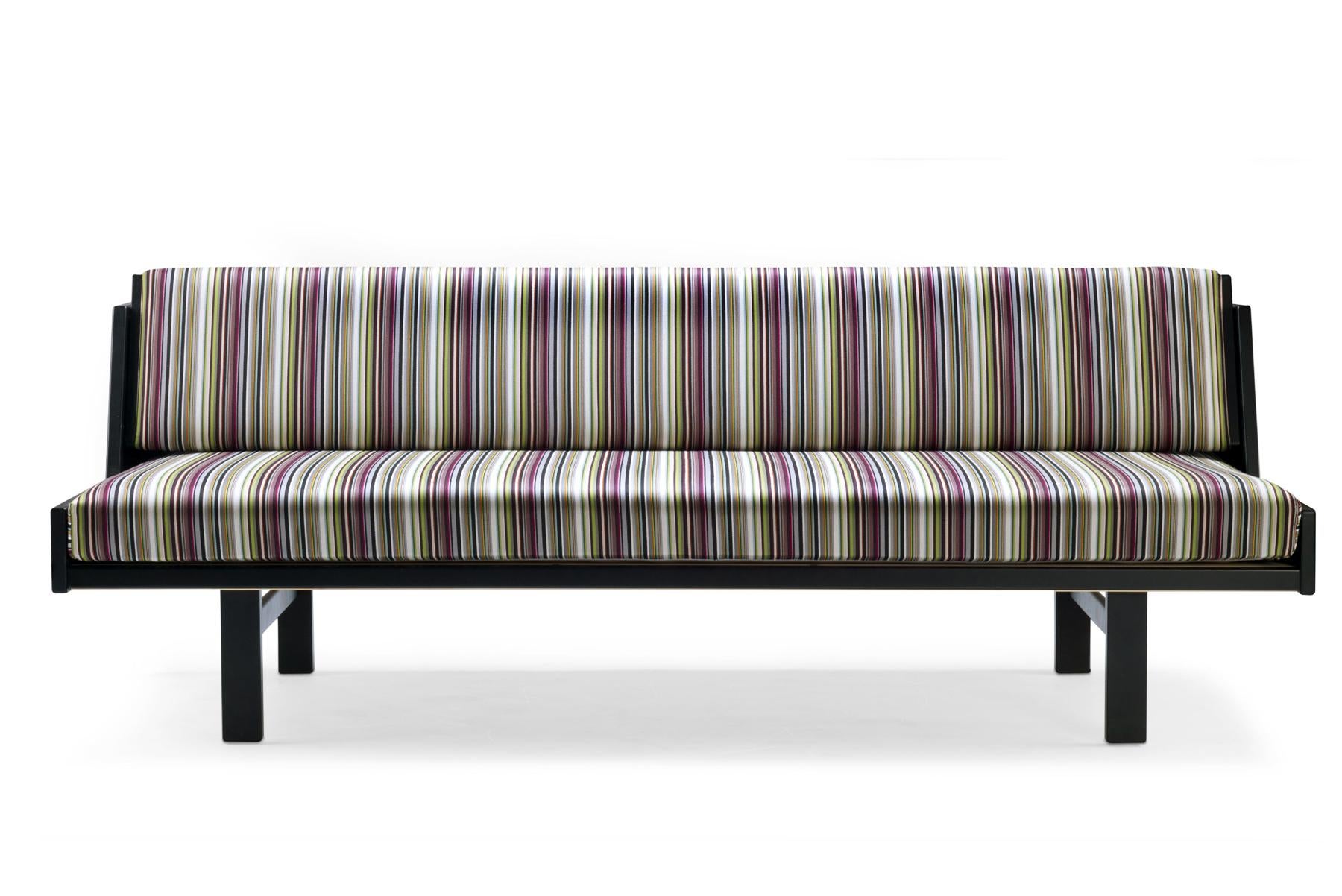 Conçu par Hans Wegner en 1954, le lit de jour GE 258 est un meuble polyvalent. Le dossier rembourré se soulève pour offrir un lit spacieux. Fabriqué en bois massif, ce banc est construit à la main dans l'usine de GETAMA à Gedsted, au Danemark, par