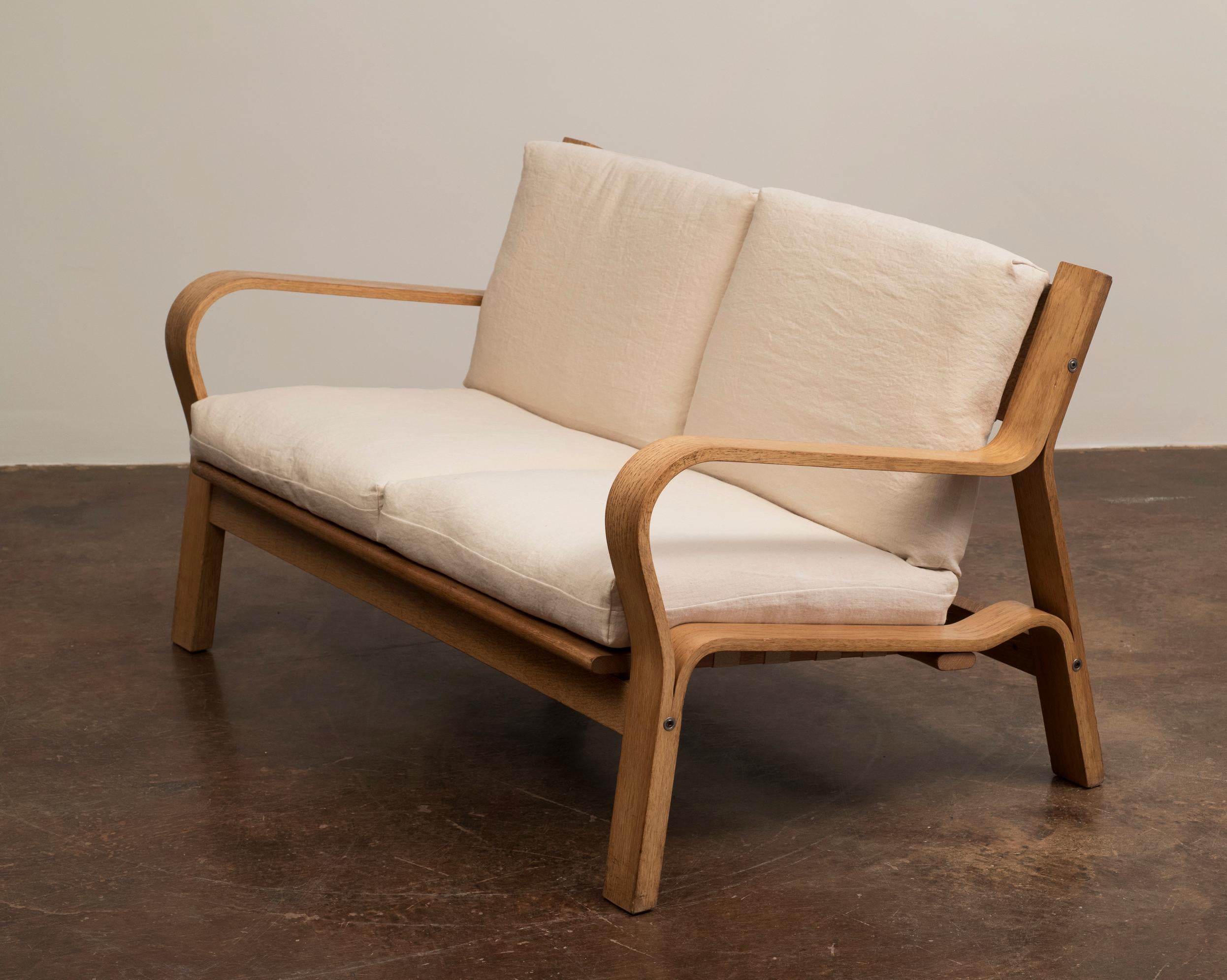 An iconic Hans Wegner settee with flag halyard seat back and webbed seat support for GETAMA, 1967. 

In excellent vintage condition with new cushions in Libeco linen. Existing seat webbing has been tightened to provide appropriate support for new