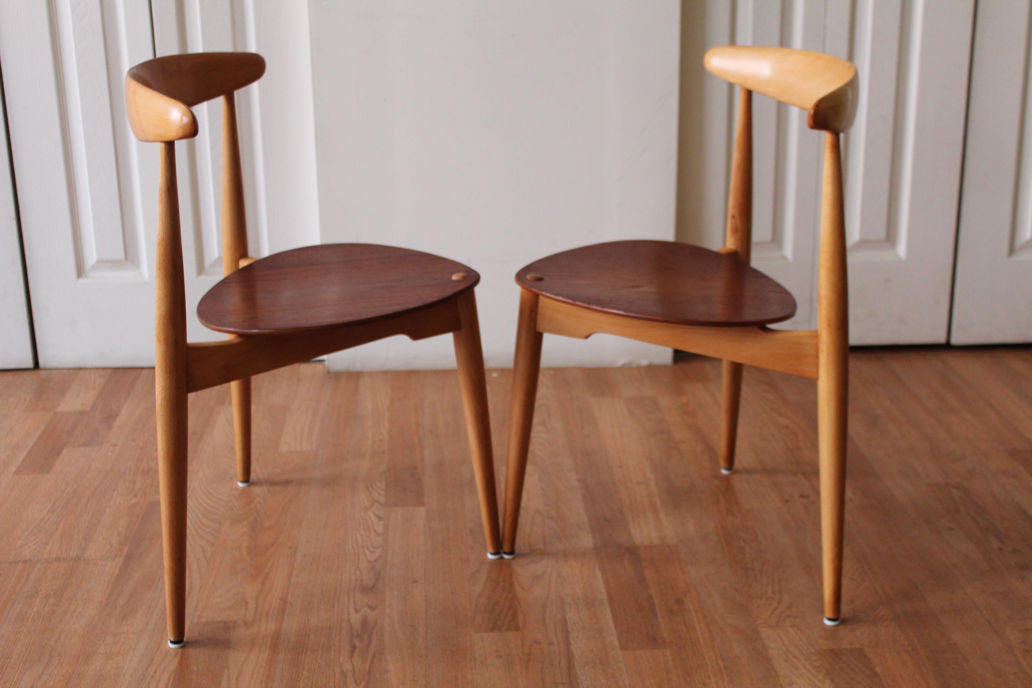 Purist alert! This pair of Danish modern stacking dining chairs is made of teak and beech. The seat is teak and the frame is beech. Freshly waxed, just for you. The 