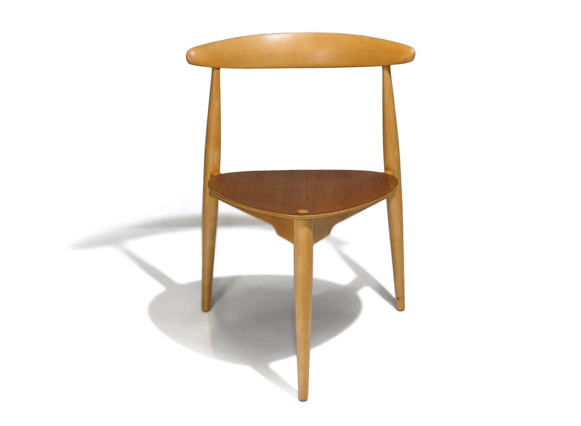 Three Heart chairs designed by Hans Wegner for Fritz Hansen, Model FH 4103, circa 1953 Denmark. The chairs are crafted of solid beech frames, with heart shape seats of teak and raised on three legs.
Measurements
W 20.50'' x D 18.50'' x H