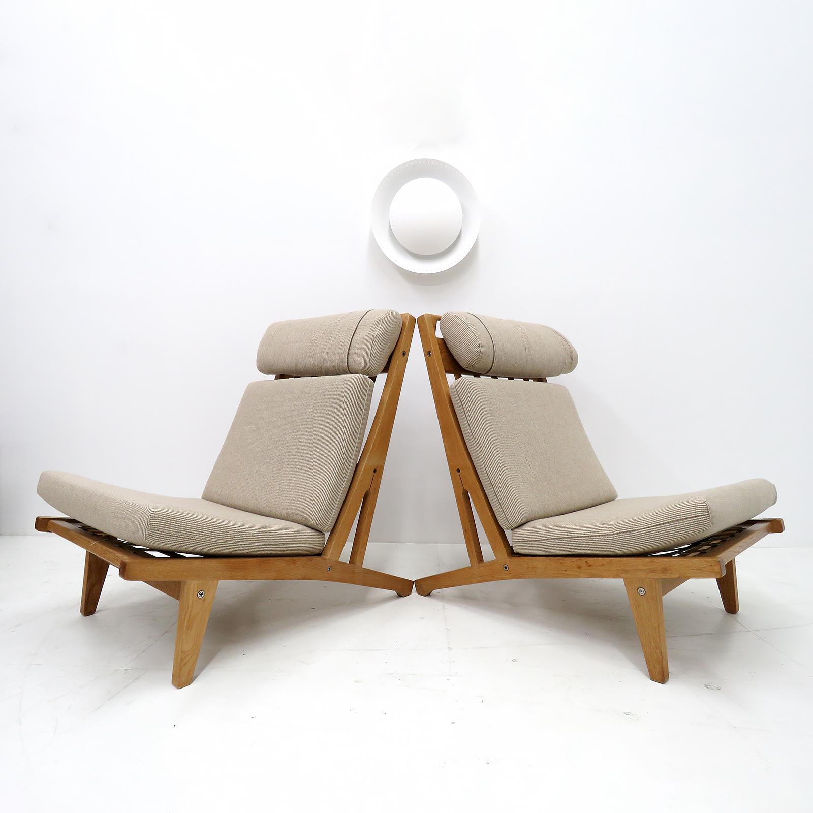 Large scale high back chair by Hans Wegner with solid oak frame and cushions in beige wool (seemingly reupholstered at a later date), produced by GETAMA in 1969, model GE 375, detachable neck cushion, original makers mark to underside. Priced