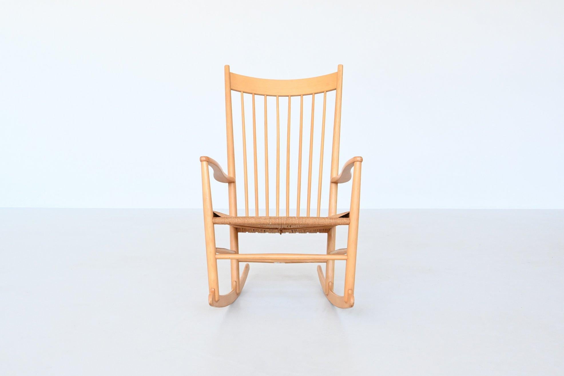Iconic rocking chair model J16 designed in 1944 by Hans J. Wegner and manufactured by Kvist Møbler, Denmark 1970. Stunning example of Danish design with the sensually curved arms inspired by traditional Windsor and Shaker furniture, fused with