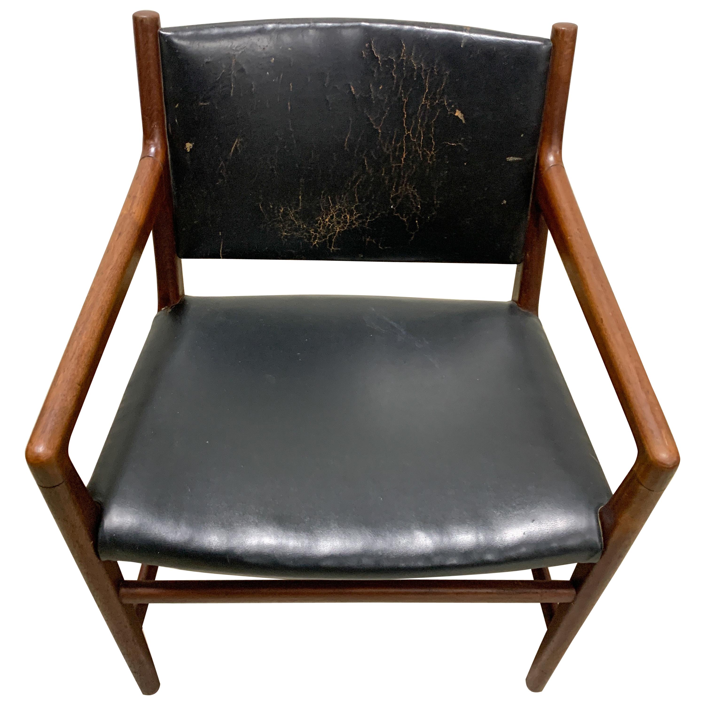 This is a very rare teak armchair designed by Hans Wegner and produced by Johannes Hansen in 1950. The JH-507 in teak and leather was only produced in limited quantities and is a hard piece to find. The chair boasts the original leather on its seat