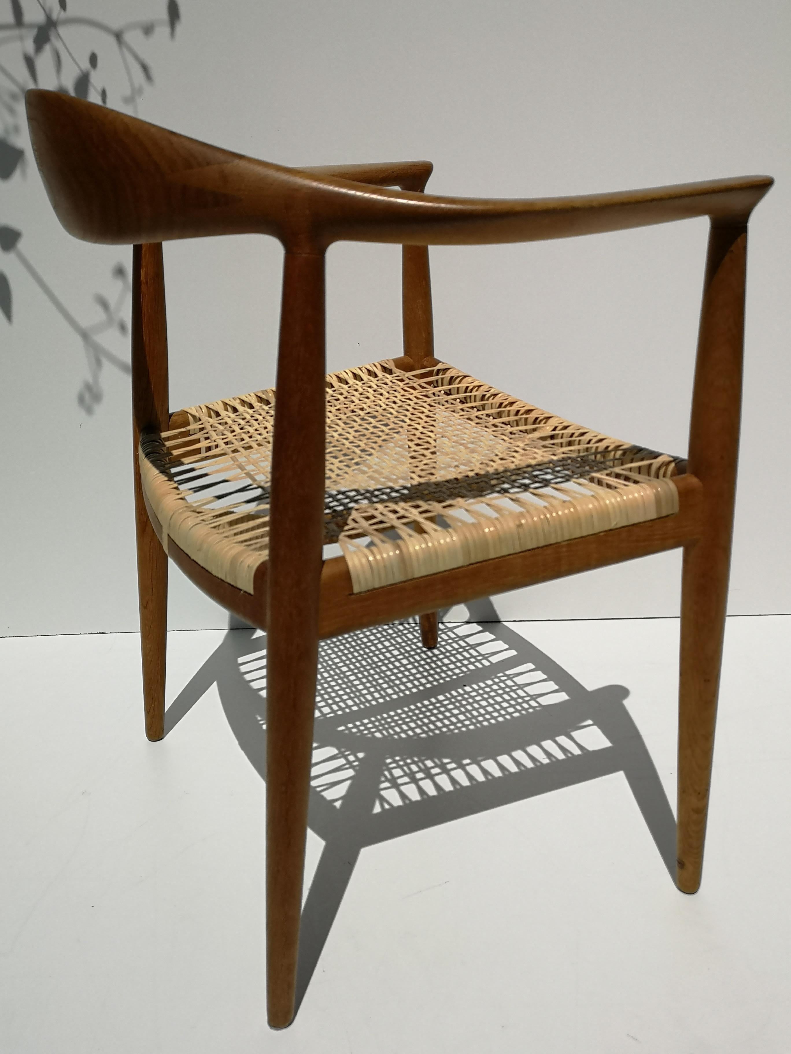 Early, and very rare variant of Hans Wegner's JH501 chair in oak and cane, by Johannes Hansen, circa 1950s. This uncommon piece features a two piece backrest, possibly produced for a short time between production of the JH501 and JH503. Freshly