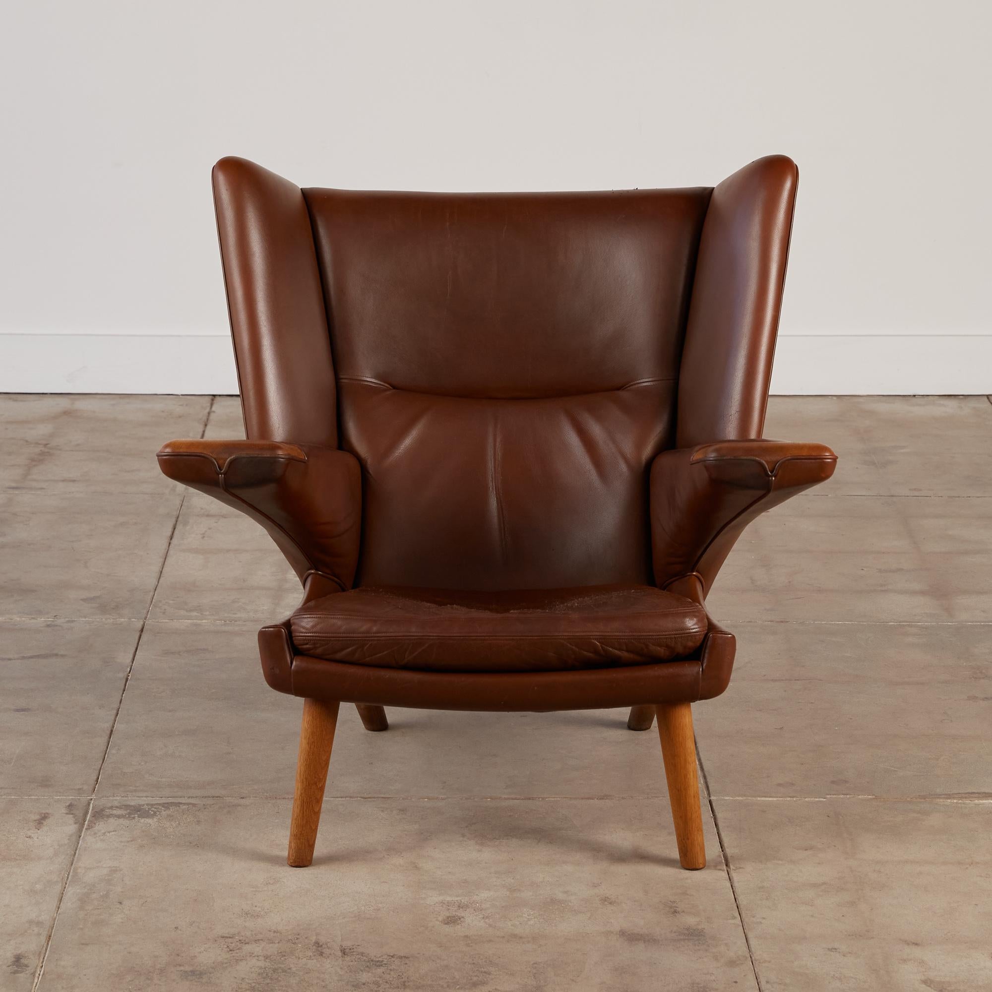 A rare edition of Hans Wegner's most iconic chair, the Mega Papa Bear Chair. This piece has all the elements of the classic Papa Bear Chair: elegant paneled detailing in the backrest upholstery, a dramatic wing-back, and cantilevered arms. The