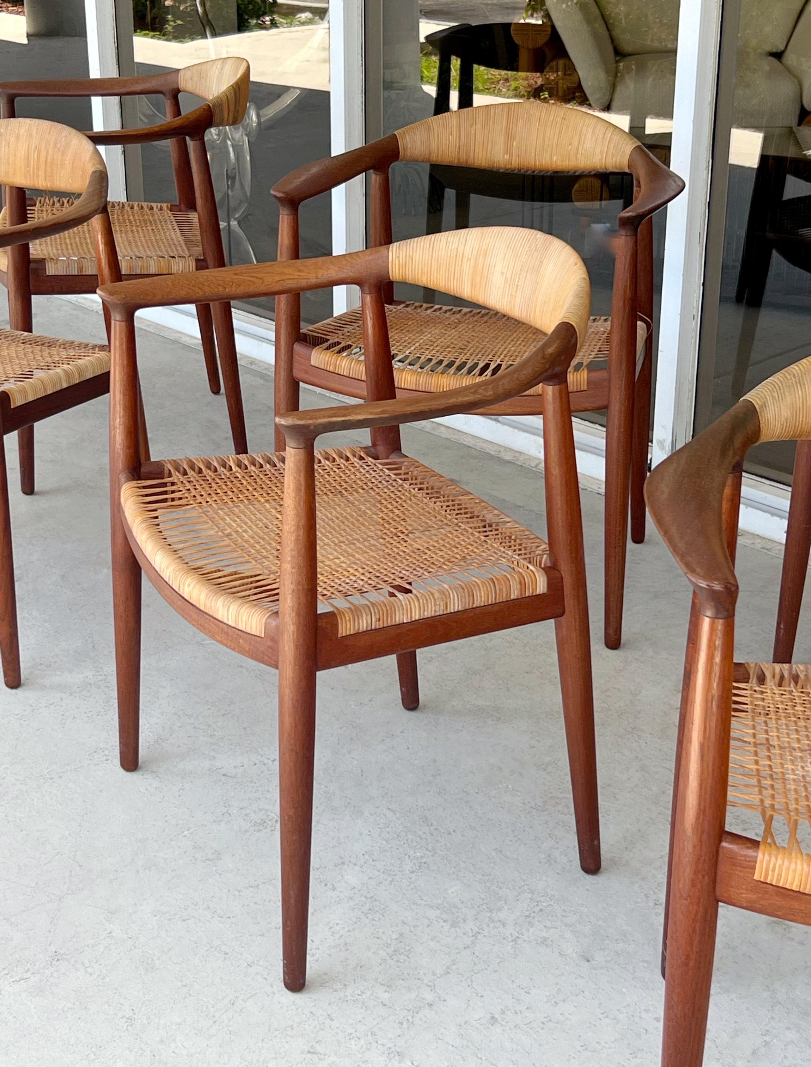 Hans Wegner Mid Century Teak The Chair with Cane Seats - Set of 6  

These chairs measure: 25 wide x 18 deep x 29.75 inches high, with a seat height of 17 and arm height/chair clearance of 27.25 inches

A set of very early armchairs by Hans Wegner
