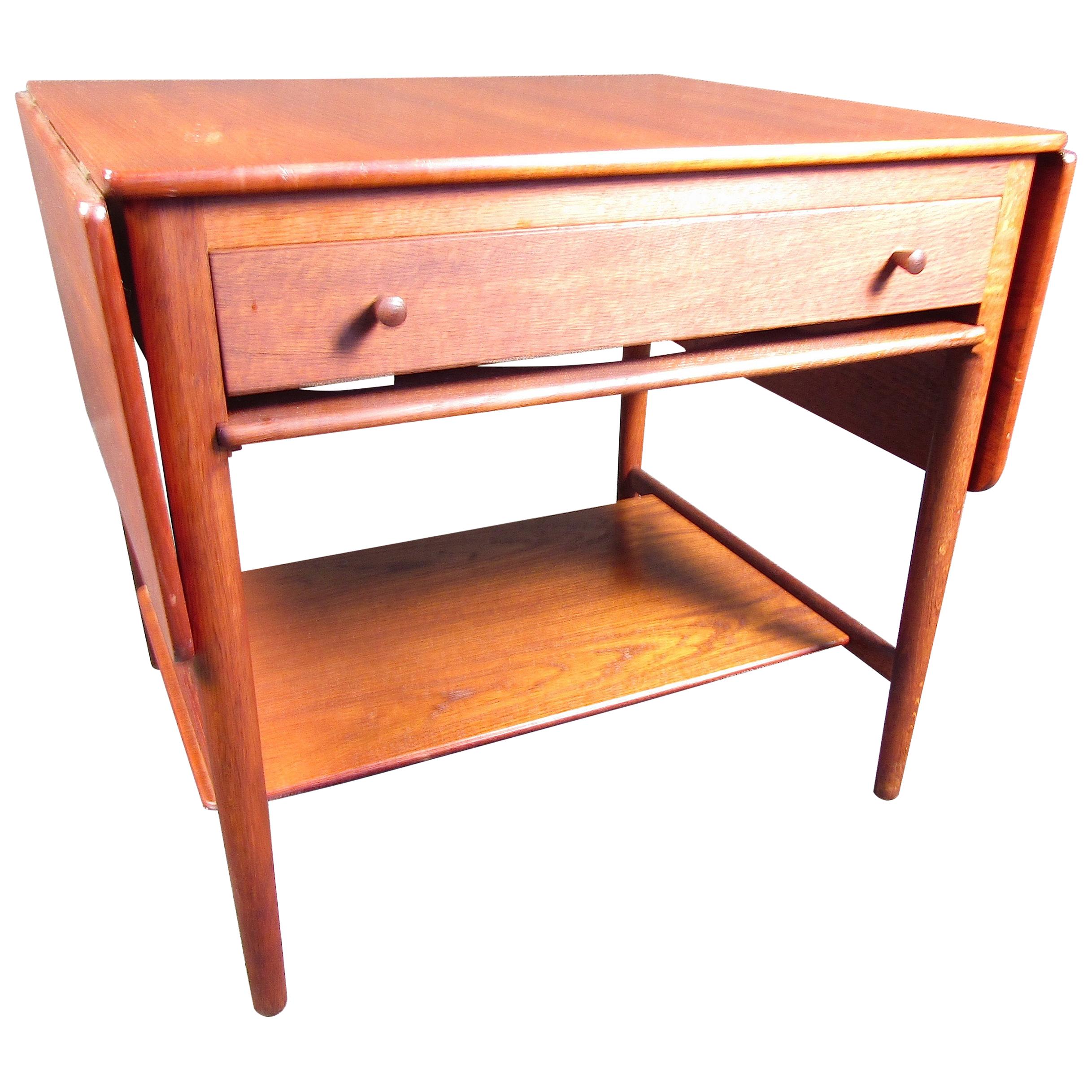 This beautiful Hans Wegner sewing table features beautiful rosewood along with fold-out table extensions. It has an intricate organizer drawer to keep all your supplies in a neat fashion.