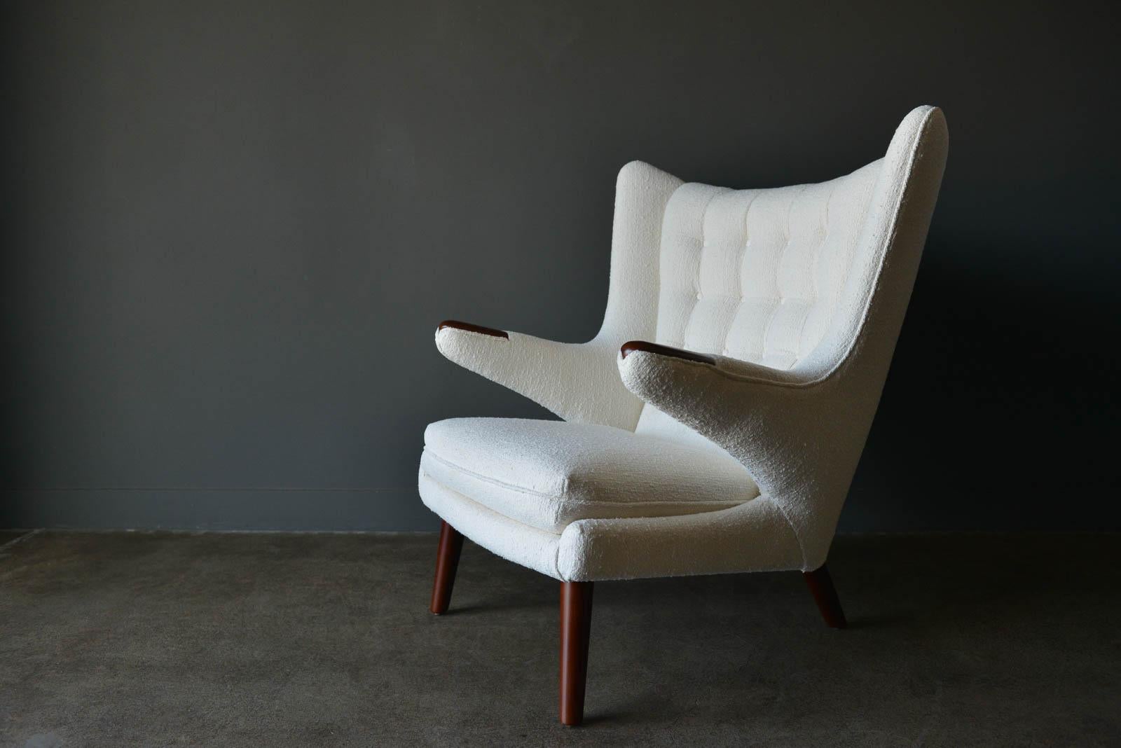 Hans Wegner model AP-19 'Papa Bear' chair, circa 1955. Considered one of his finest and most desirable and comfortable chairs, this beautiful original piece has been professionally restored with new foam and a period-correct ivory textured combed