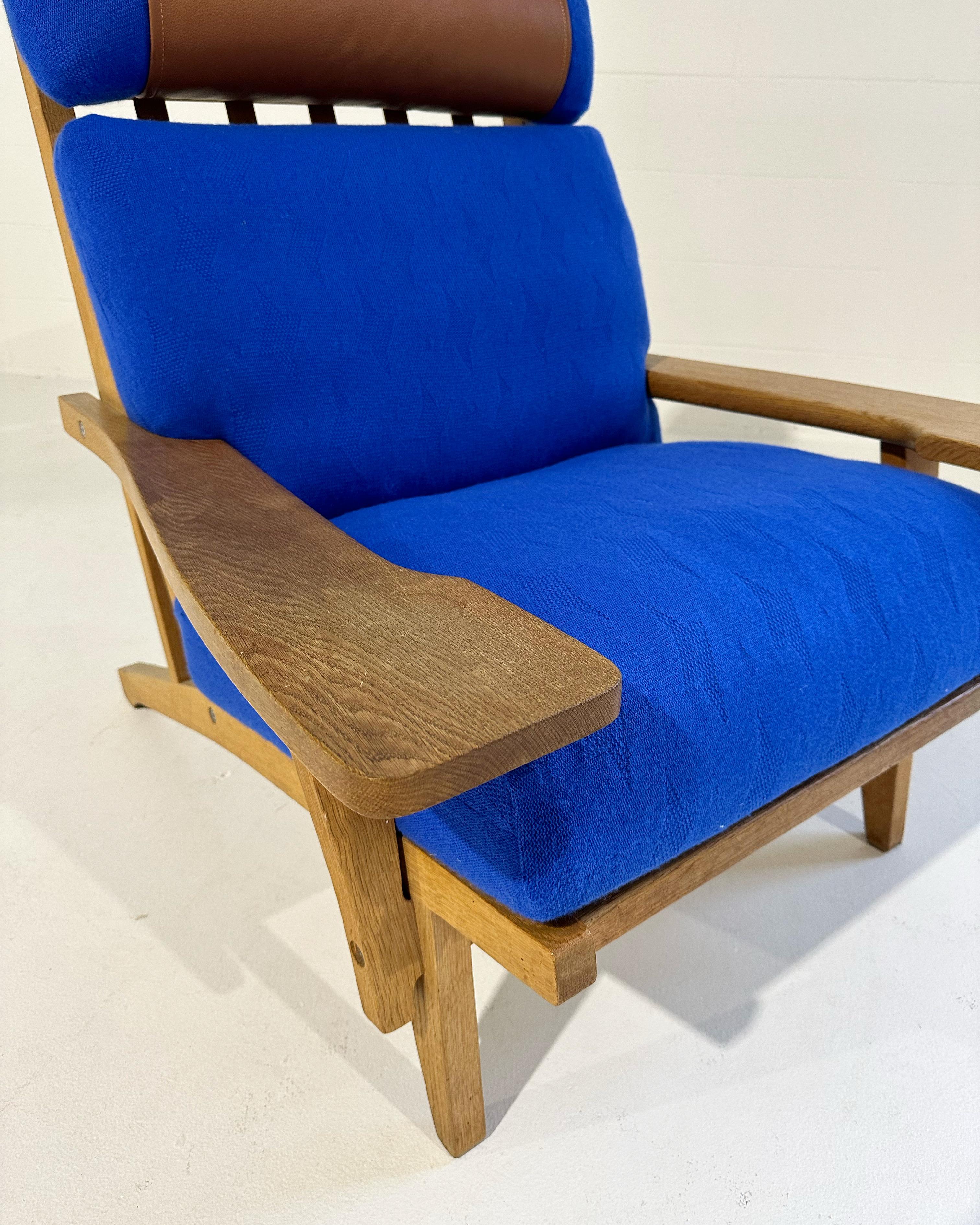 With gorgeous patinaed oak, custom cushions handcrafted from cashmere throws by  Saved NY, and a finishing touch of beautiful Loro Piana leather, this one-of-a-kind Hans Wegner lounge chair is incredible. We love the caramel leather and Klein blue