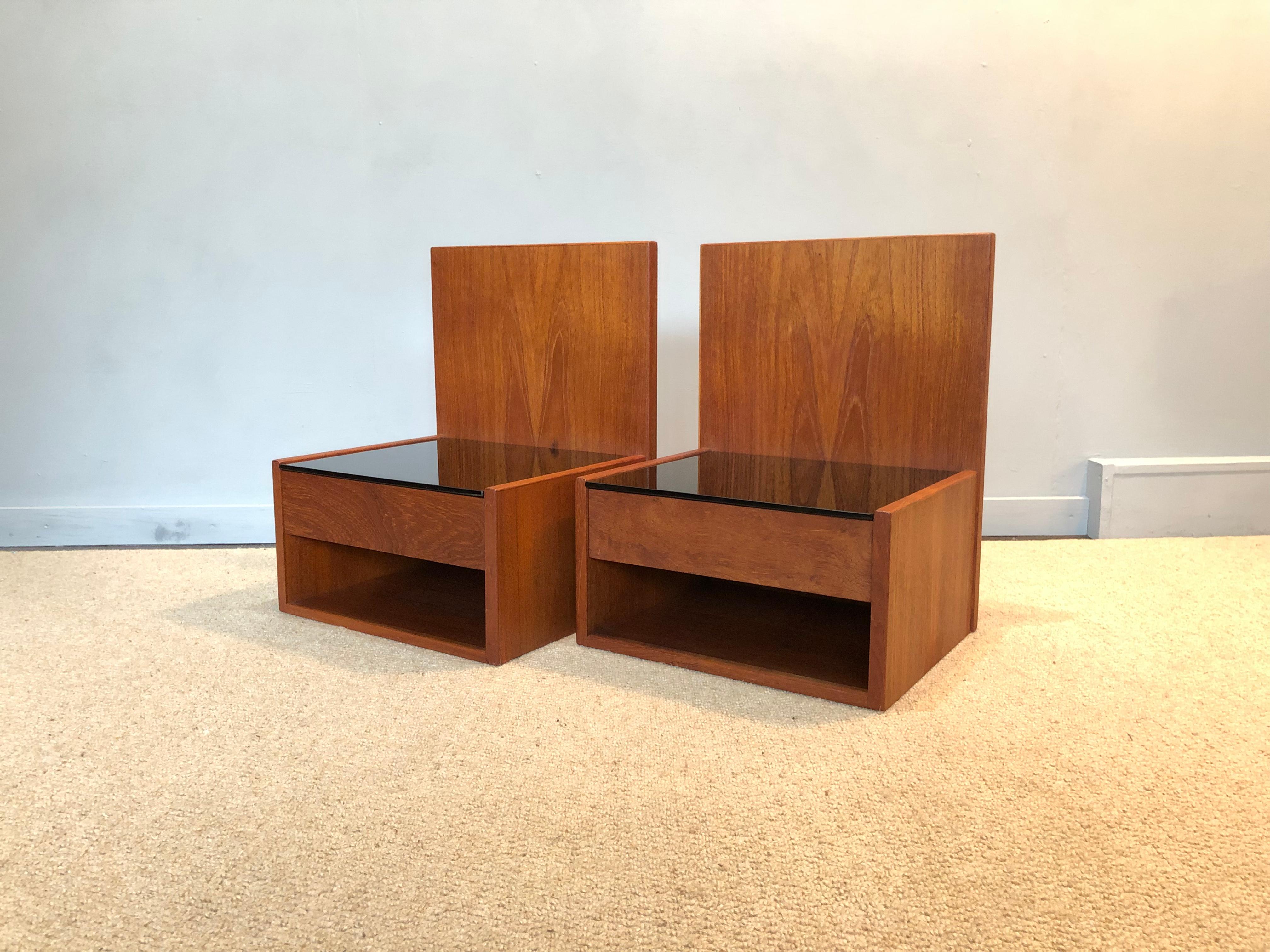 A pair of original Danish midcentury 1960s Hans J Wegner nightstands. Constructed from teak with a black glass surface. Manufactured by GETAMA, Denmark. Beautifully modernist design from the Danish master. These are designed to be ‘floating’