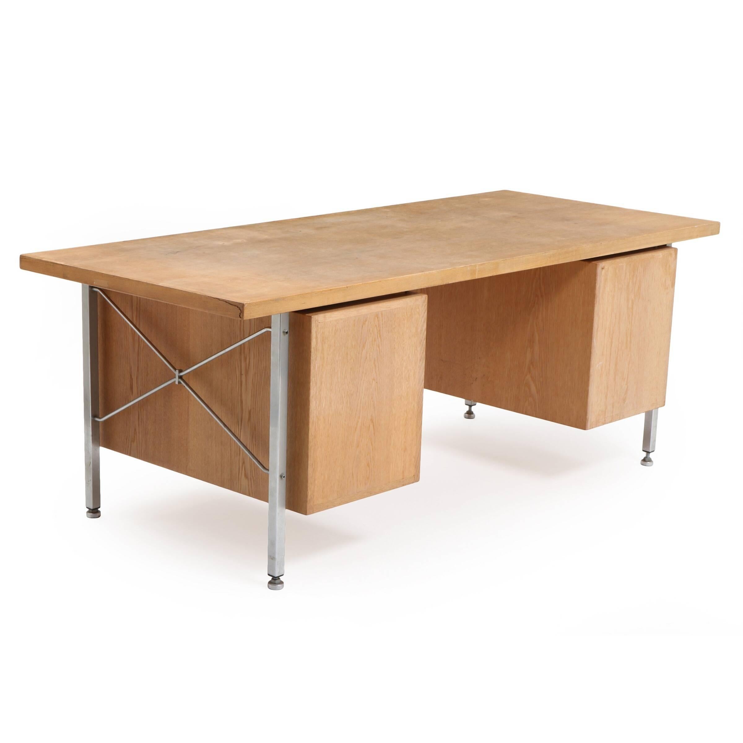 Designed by Hans Wegner, this oak desk with chromed steel frame and legs six drawers and two pull-out leaves. Made by cabinetmaker Johannes Hansen or possibly Plan Mobler in the 1960s or 1970s. Measures: H 73, L 197, W 82 cm.

  