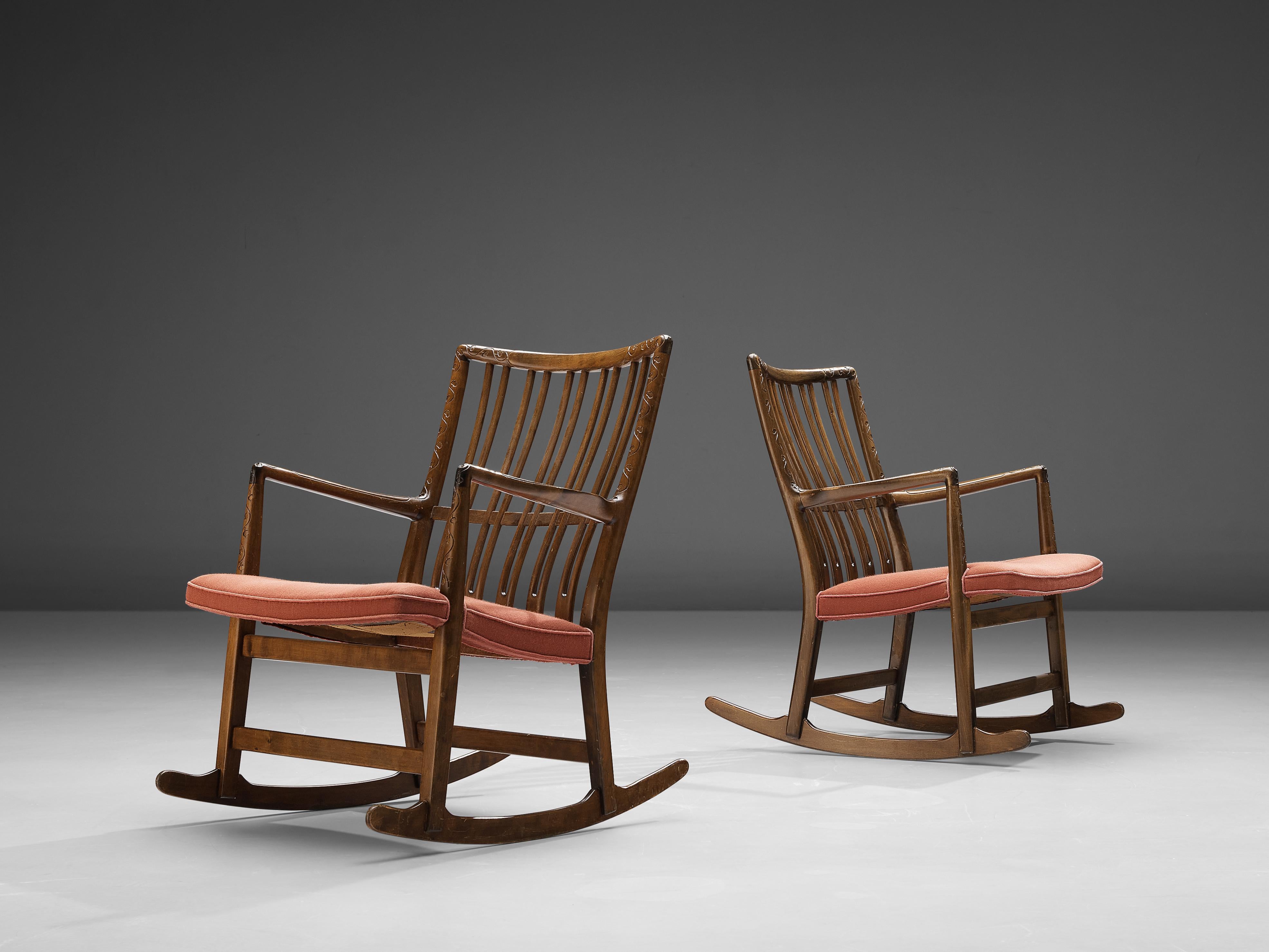 Hans Wegner for Mikael Laursen, pair of ML-33 rocking chairs, beech, fabric upholstery, Denmark, 1940s
 
Hans Wegner designed the ‘ML-33’ rocking chair for Laursen in the 1940s. The wooden frame features an elegant backrest with slim, vertical slats