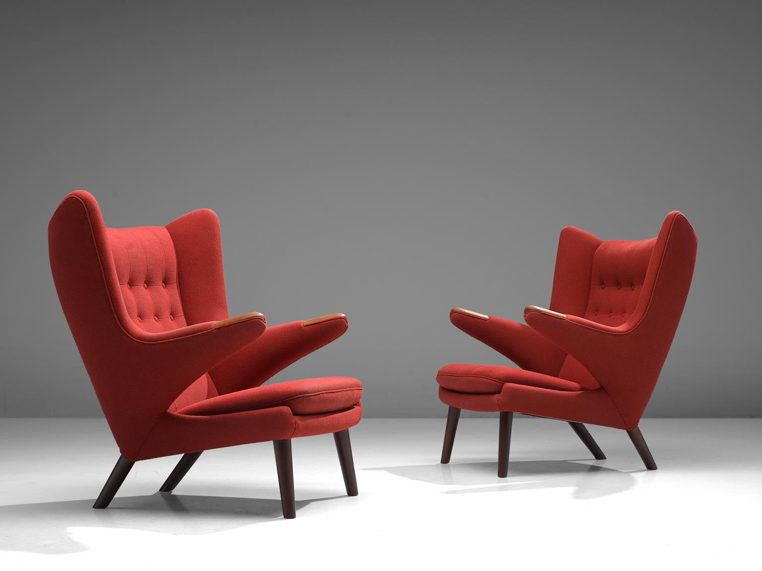 Hans J. Wegner by AP Stolen, pair of lounge chairs Model AP 19 'Papa Bear', red fabric and beech, Denmark, 1951.

This pair of semi-wingback armchairs have an open expression in contrast with its historical ancestors. Wegner made a few