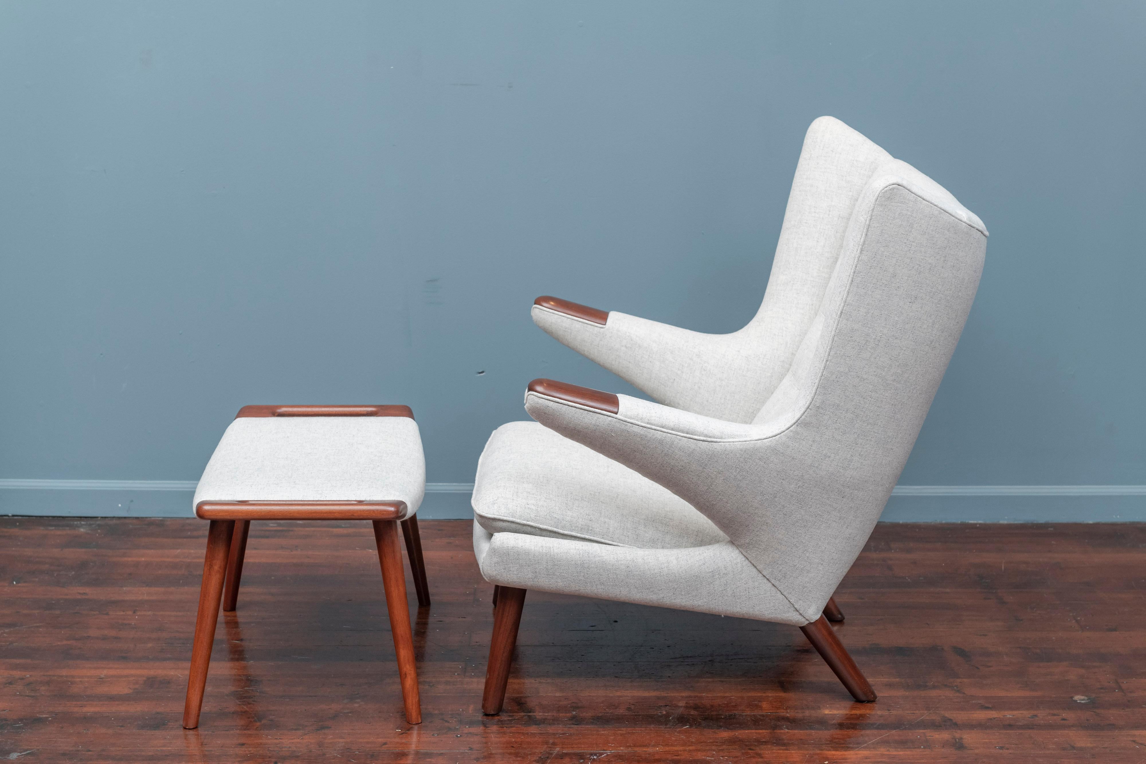 Hans Wegner papa bear chair and ottoman, the more desirable early teak legs and arm pads version. 
Newly refinished and upholstered in a very light grey Danish wool, ready to enjoy.