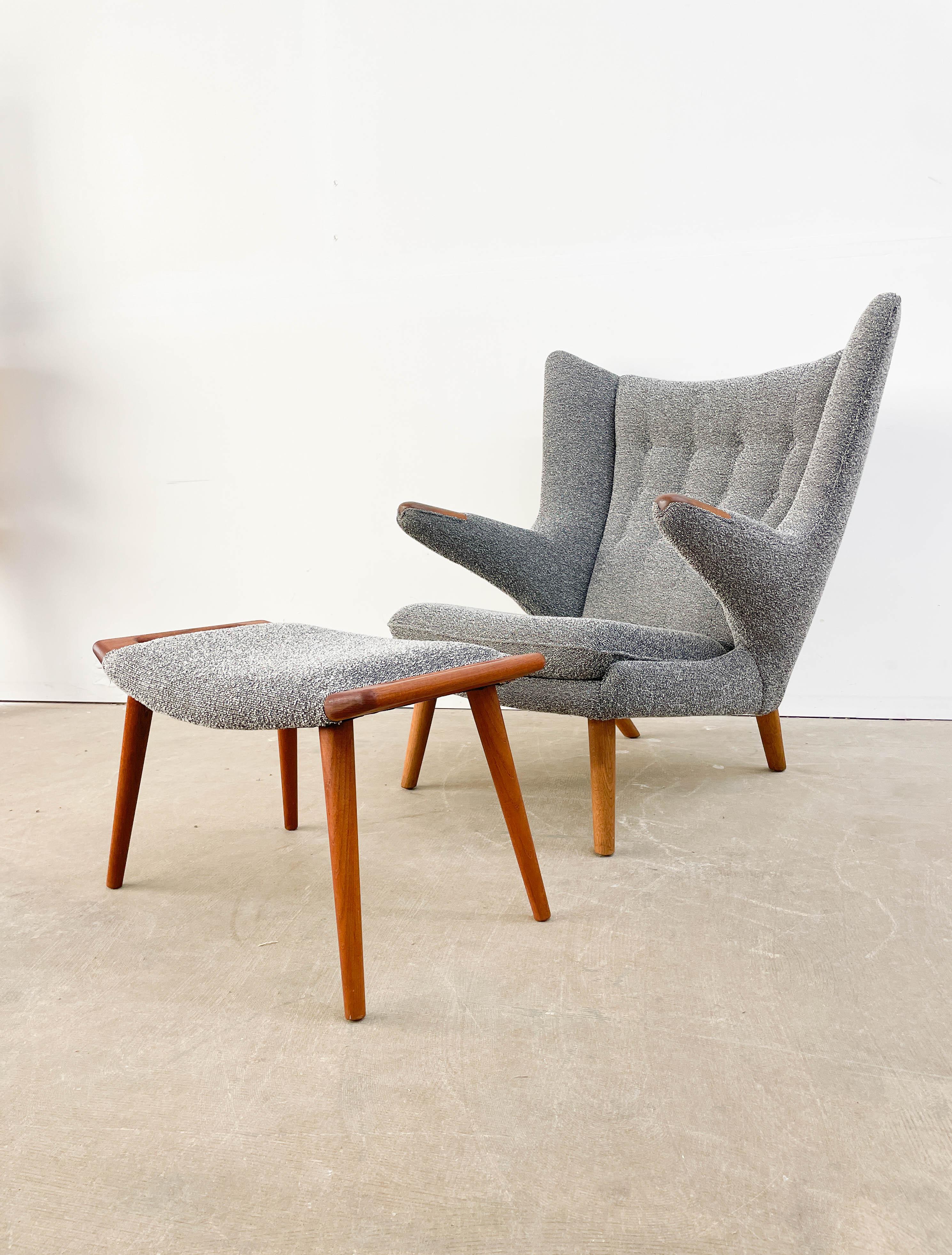 This is a superb example of Hans Wegner's iconic AP19 'Papa Bear' chair. The iconic was designed in 1951 and prized for its superb comfort and striking form. This example was reupholstered in the 1990s in an excellent Kvadrat speckled gray wool for