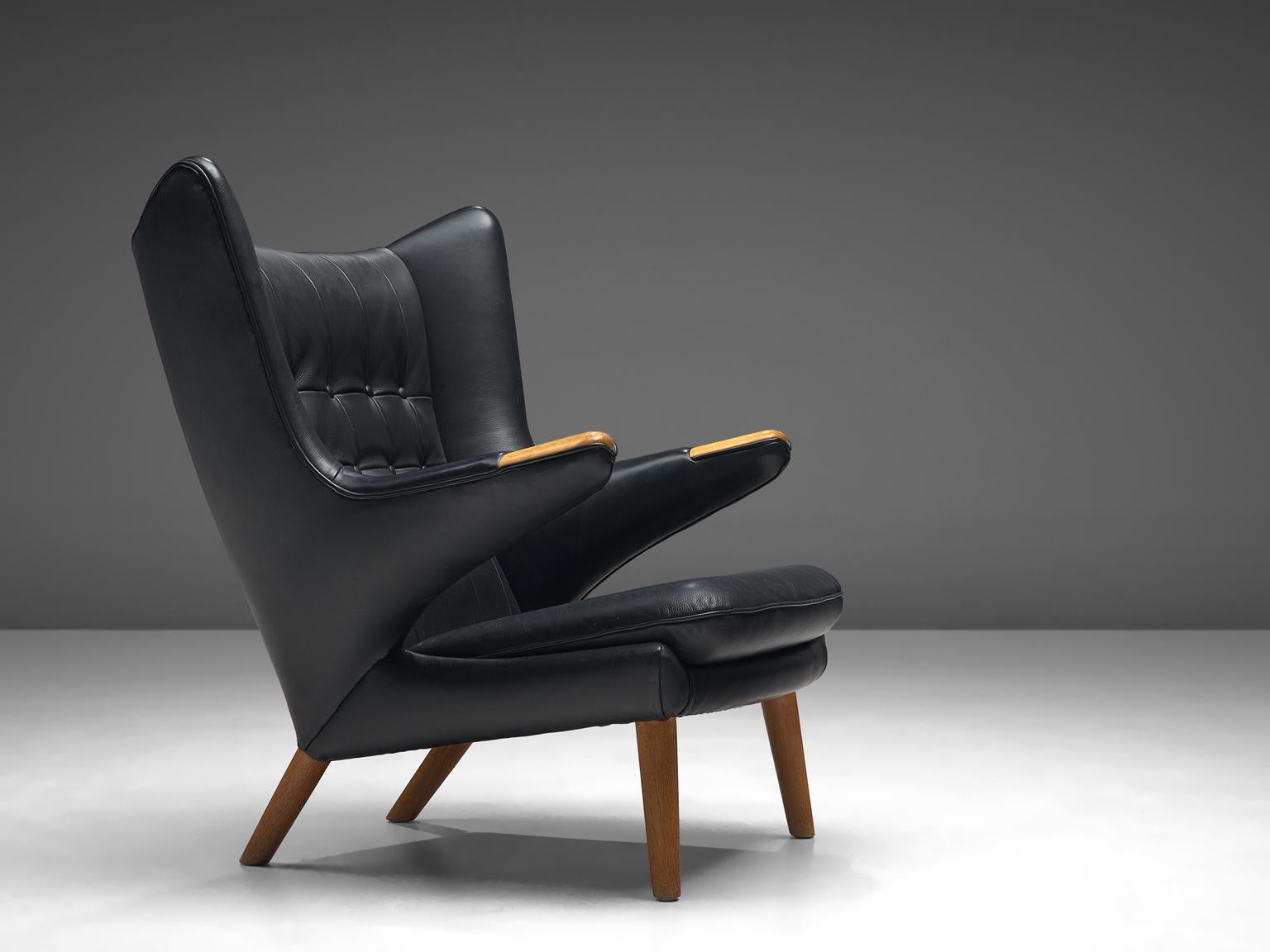 Hans J. Wegner by AP Stolen, lounge chair Model AP 19 'Papa Bear', black leather and beech, Denmark, 1951 design, production late 1950s.

This semi-wingback armchair, has an open expression in contrast with its historical ancestors. Wegner made a