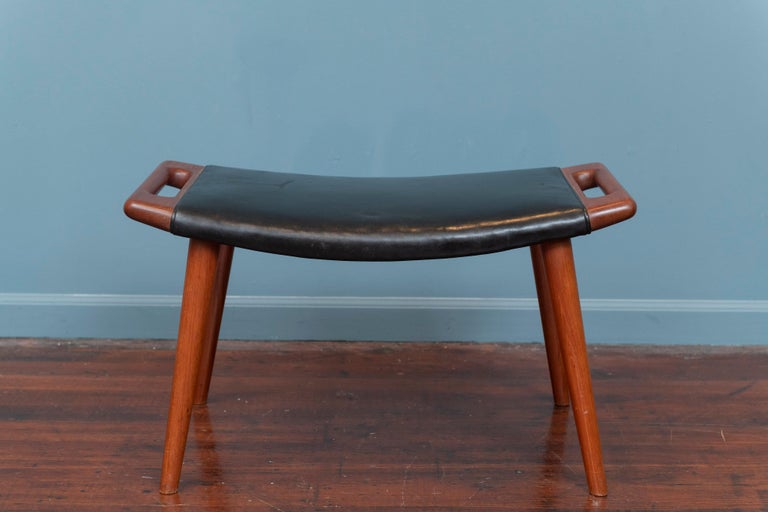 Hans Wegner Papa Bear chair ottoman, model AP-29. Perfect as a casual bench or stool. Made from solid shaped teak with original black leather purchased by original owner at Illums Bolighus, Denmark.