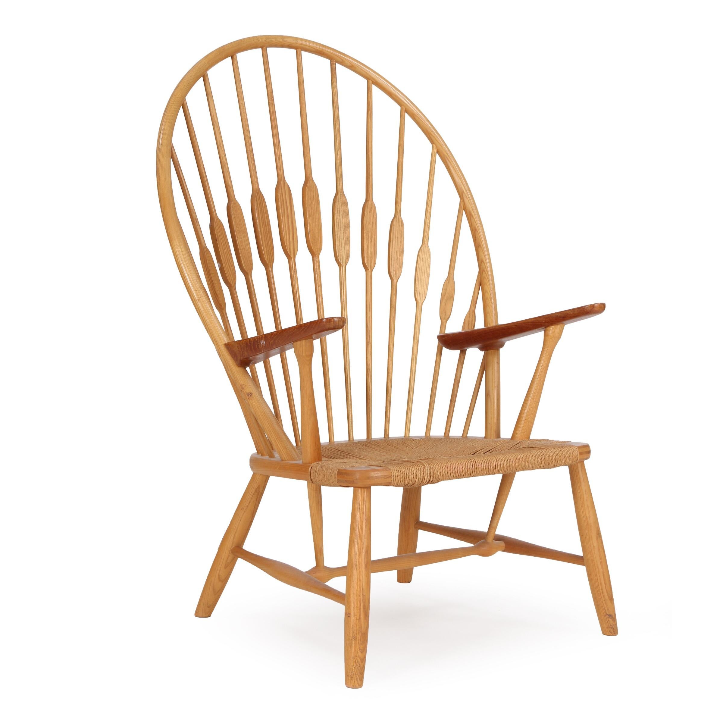 “Peacock Chair”. Easy chair with ash frame and teak armrests. Seat with woven paper cord. Model JH 550. Designed 1947. This example made approx. 1960s by cabinetmaker Johannes Hansen, stamped by maker.

Model presented at The Copenhagen