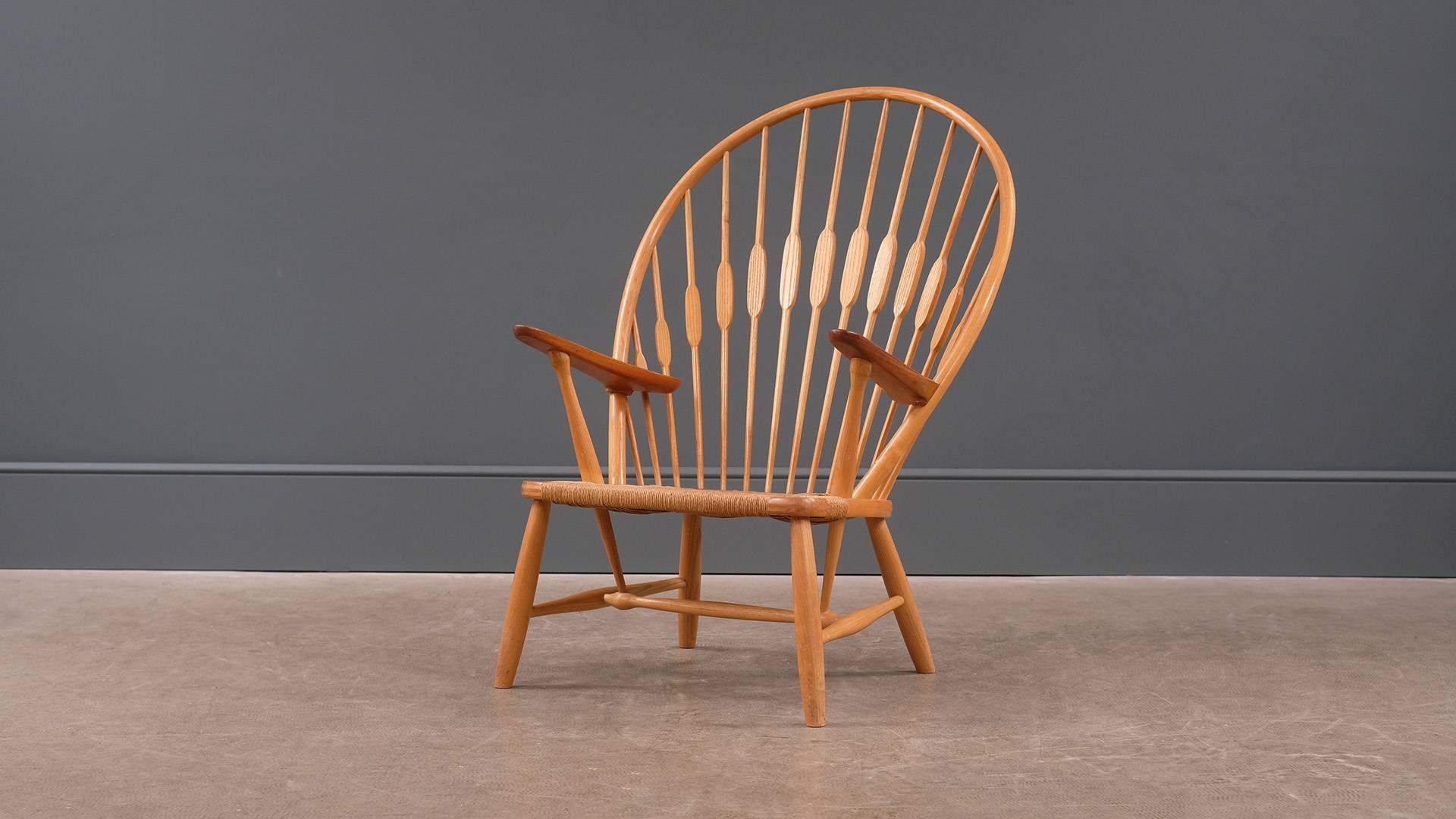 Amazing peacock chair designed by Hans Wegner, Denmark. Fantastic original early example produced by cabinet maker Johannes Hansen. Solid ash frame with contrasting teak arms. Rare and great piece.