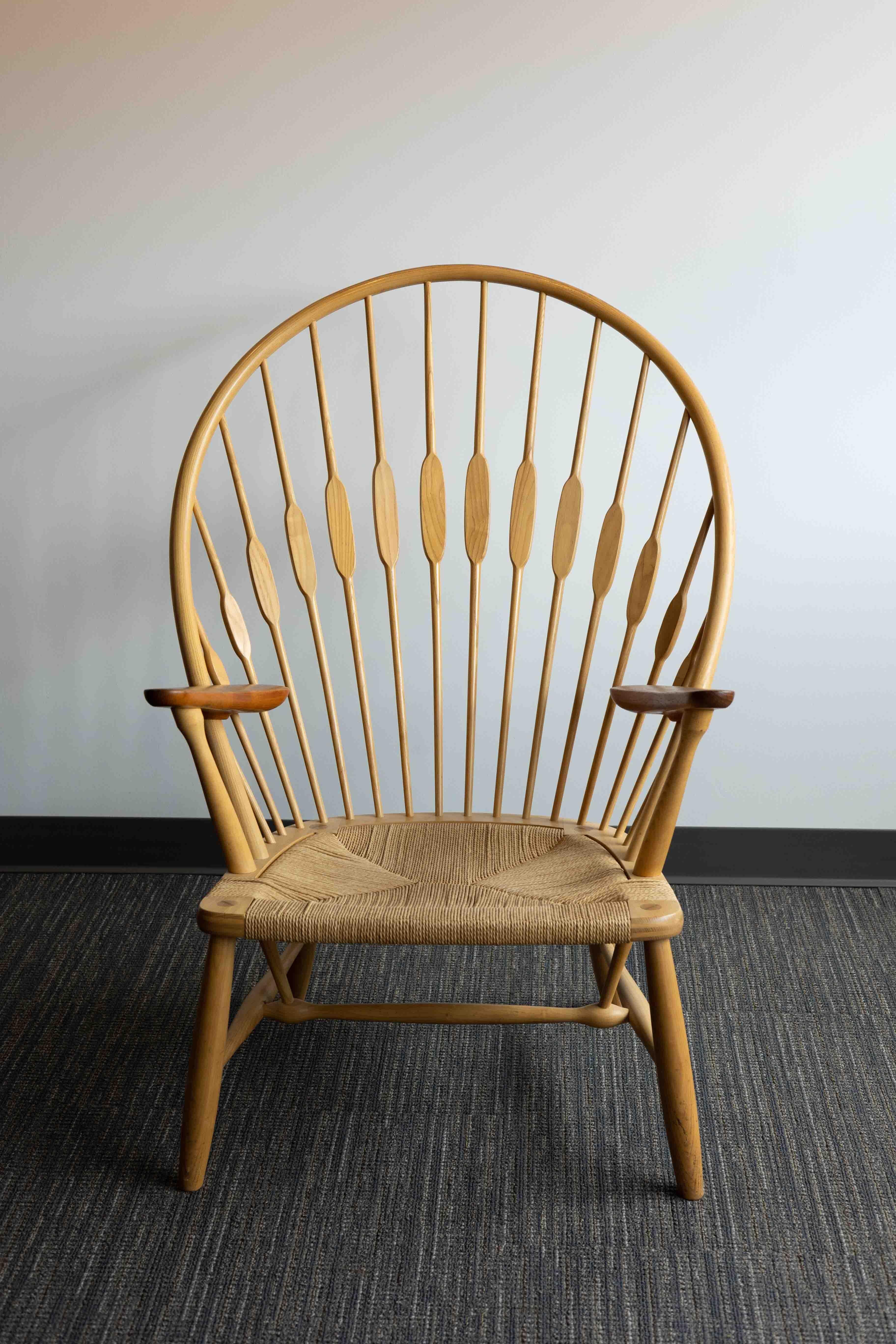 A PP550 ‘Peacock’ chair designed by Hans Wegner in 1947 for Johannes Hansen.

Modeled after a traditional American Windsor chair, Hans Wegner’s Peacock chair strips the form to reveal its construction while retaining aesthetic, decorative impact.