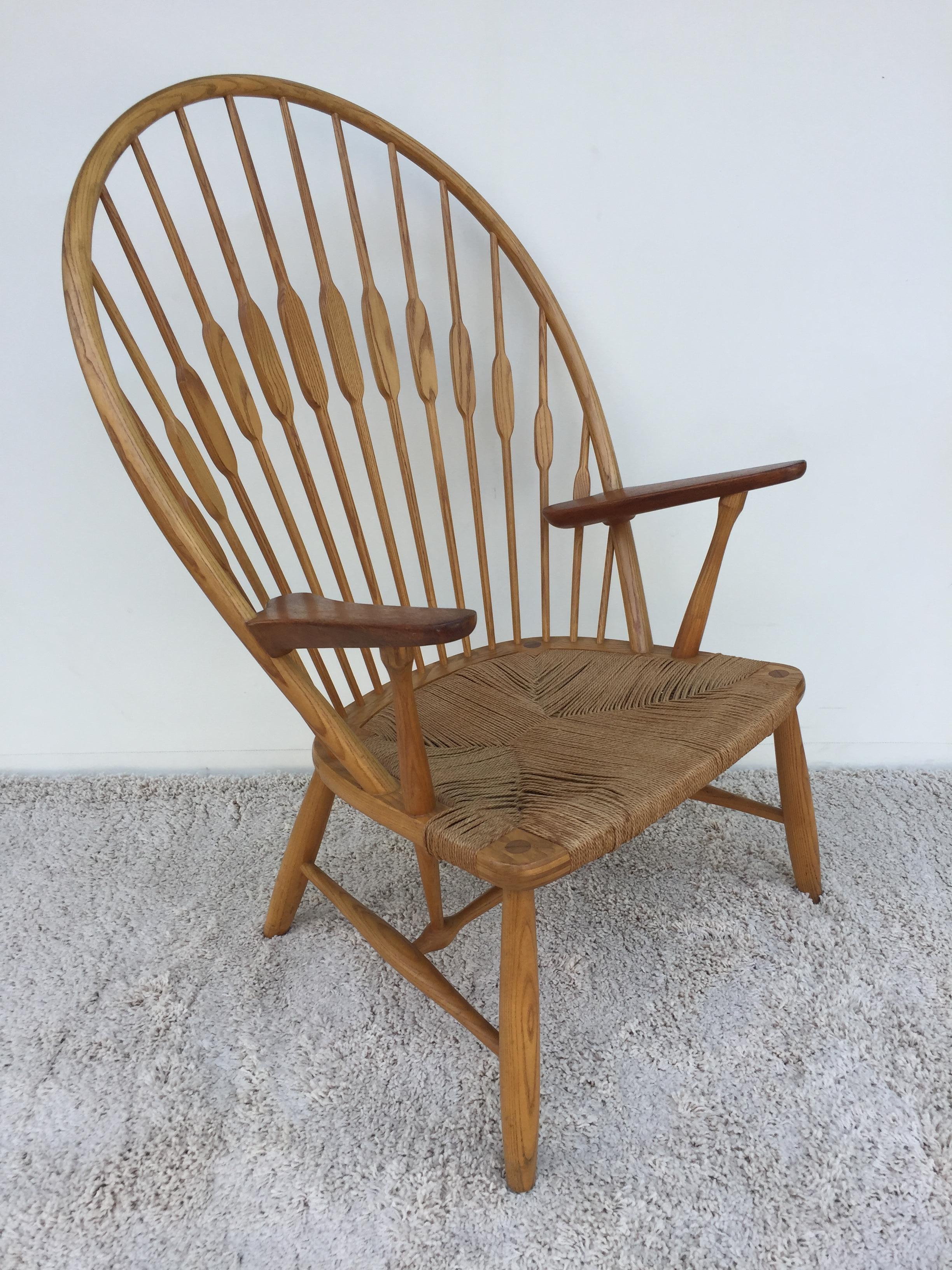 Hans Wegner light oak peacock chair, with all original rope cane seat, and finish. Stamped branded and paper label under seat. In wonderful condition.