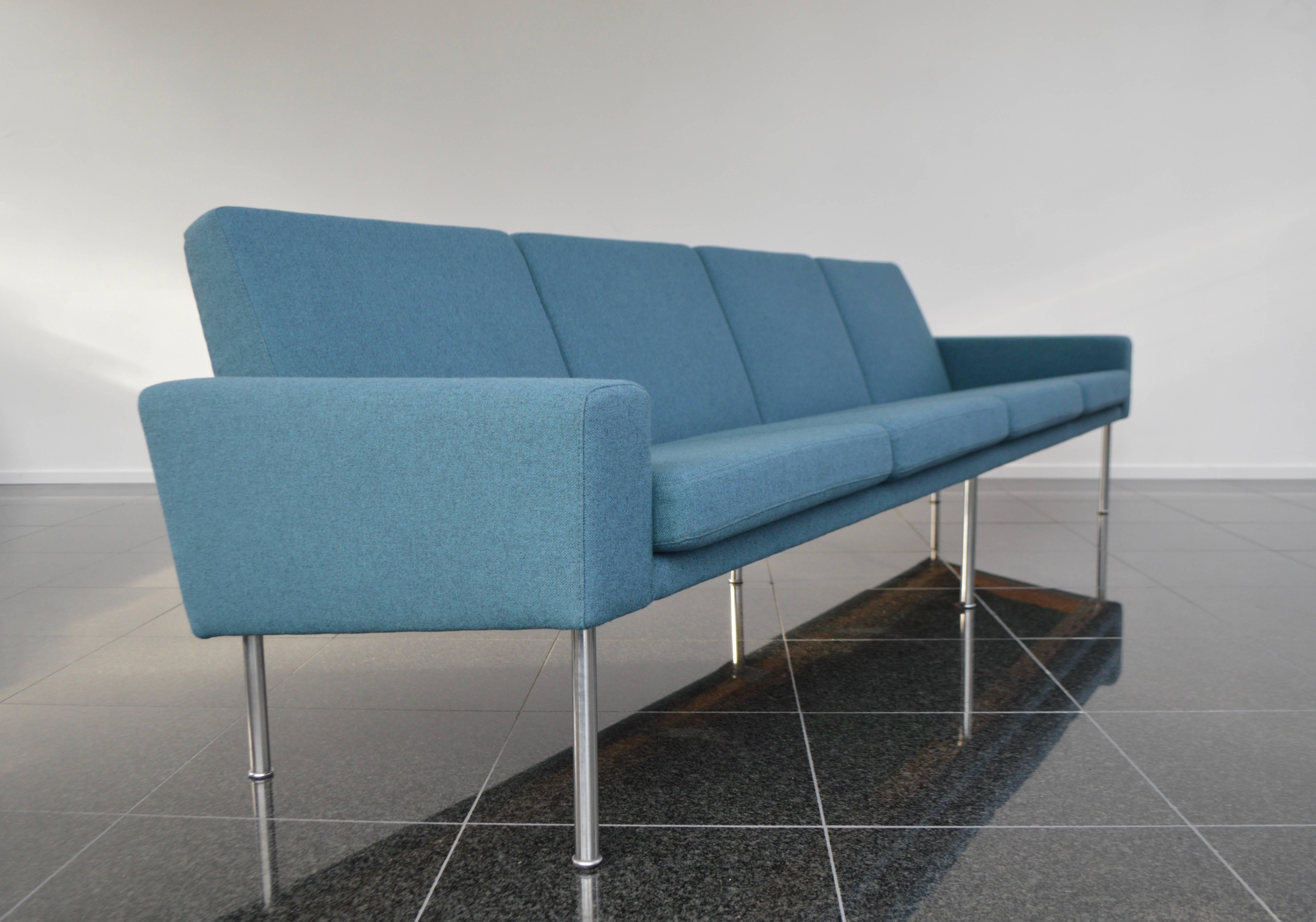 Hans Wegner four-seat airport sofa model 34/4 by AP-stolen, designed in 1957.
Sofa is upholstered in a petrol-blue and black Kvadrat fabric. The back support cushions are fastened to the frame so that they cannot change shape, which benefits the