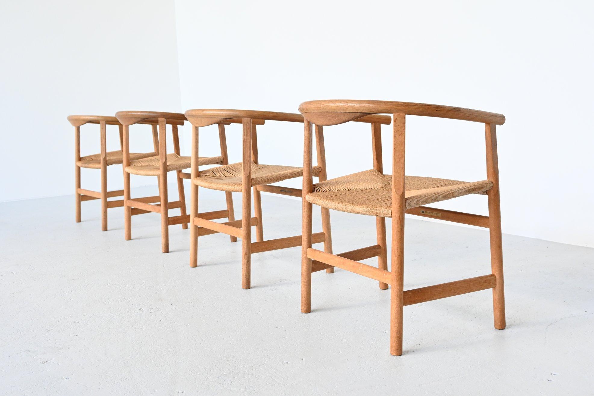 Fantastic rare set of 4 dining chairs designed by Hans J. Wegner and manufactured by PP Møbler, Denmark 1969. This is a set of 4 early examples in very nice original condition. These chairs are made of solid oakwood and have paper cord seats. They