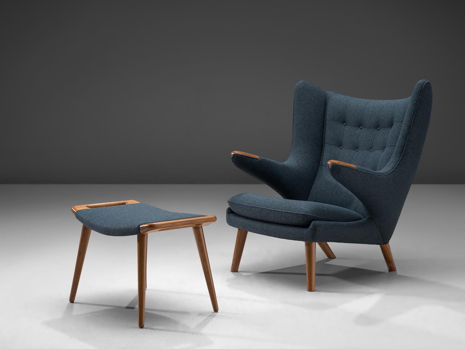 Hans J. Wegner by AP Stolen, lounge chair Model AP 19 'Papa Bear with footstool, Denmark, 1951 design, production late 1950s, blue fabric reupholstery.

This semi-wingback armchair, has an open expression in contrast with its historical ancestors.
