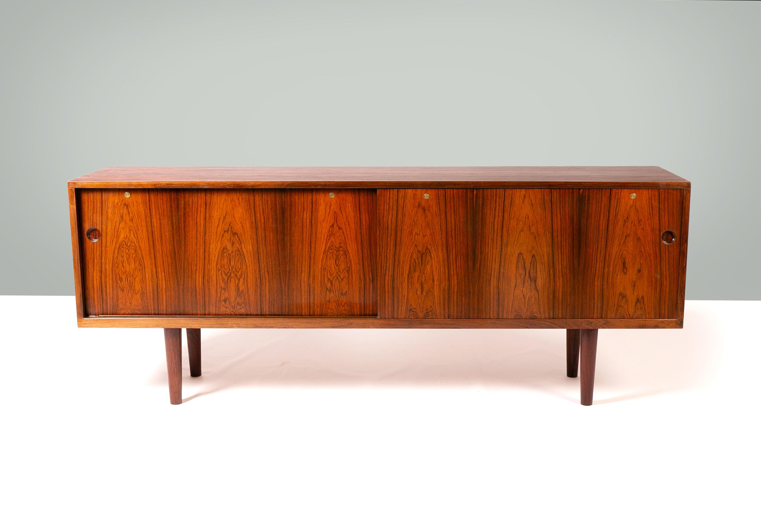 Hans Wegner rosewood sideboard RY26 made by RY Mobler, Denmark 1950’s.

This beautiful Hans Wegner Ry26 sideboard, designed in 1948 for Ry Møbler, embodies the pinnacle of Danish modern design with its clean lines, superior craftsmanship, and