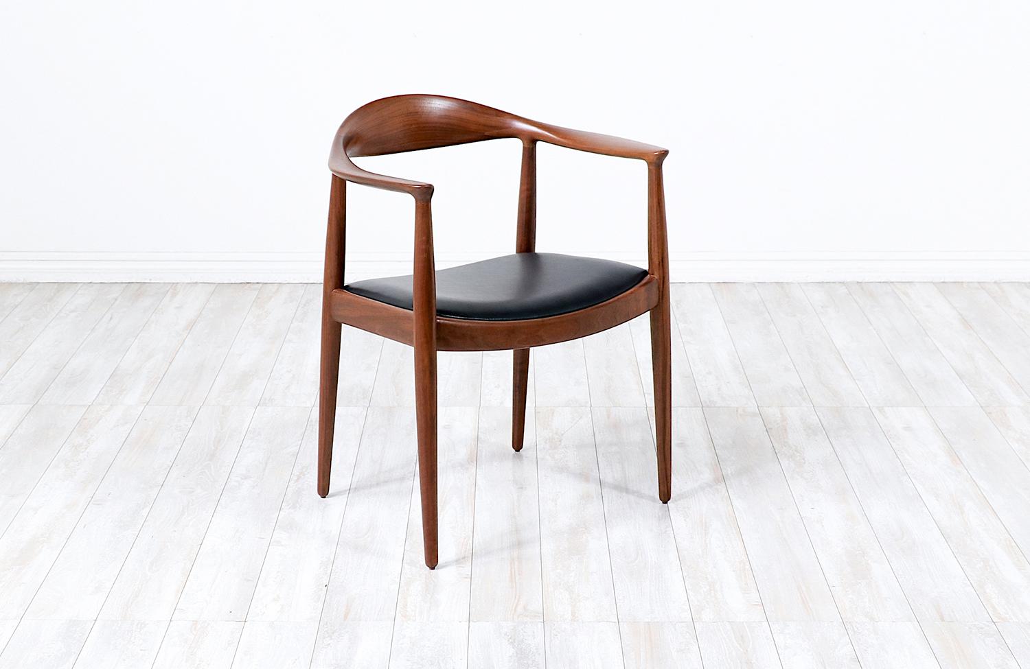 New Top-Grain Leather ‘Round’ chair designed by Danish craftsman, Hans J. Wegner, for cabinetmaker Johannes Hansen in Denmark circa 1940’s. Internationally known as “The Chair,” Wegner’s design features a curved solid walnut top rail with serrated