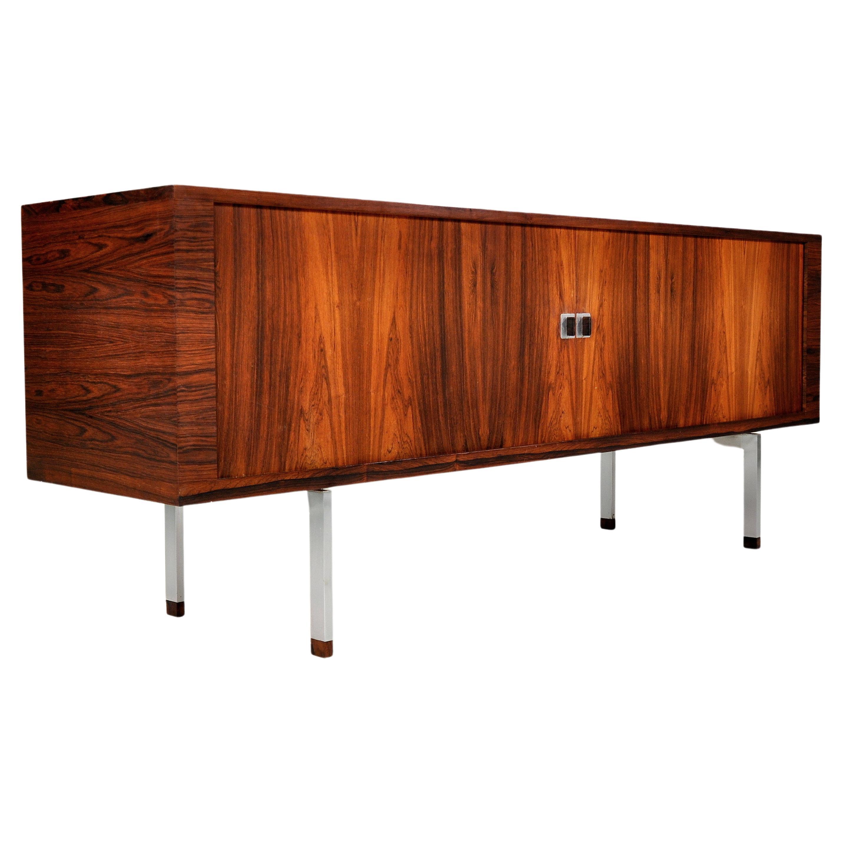 Hans J. Wegner rosewood credenza model RY25 for RY Mobler Denmark.
The rarest and most sophisticated cabinet designed by the master of Danish modern design in Brazilian rosewood and white oak on brushed stainless steel legs. Adjustable drawers and