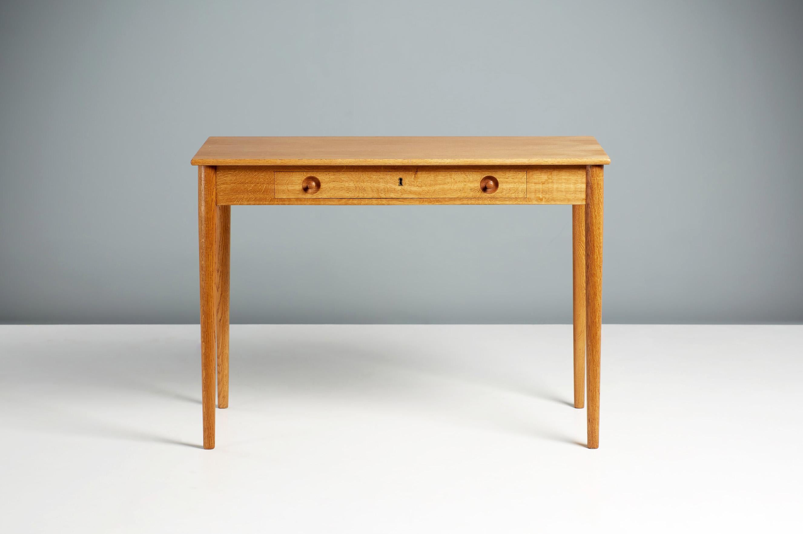 Hans Wegner RY-32 desk, circa 1960.

Oak desk from Danish icon Hans Wegner produced by Ry Mobler. The legs, drawers and frame are made from solid, patinated oak whilst the top is oak veneer. Features one lockable drawer and Wegner’s trademark
