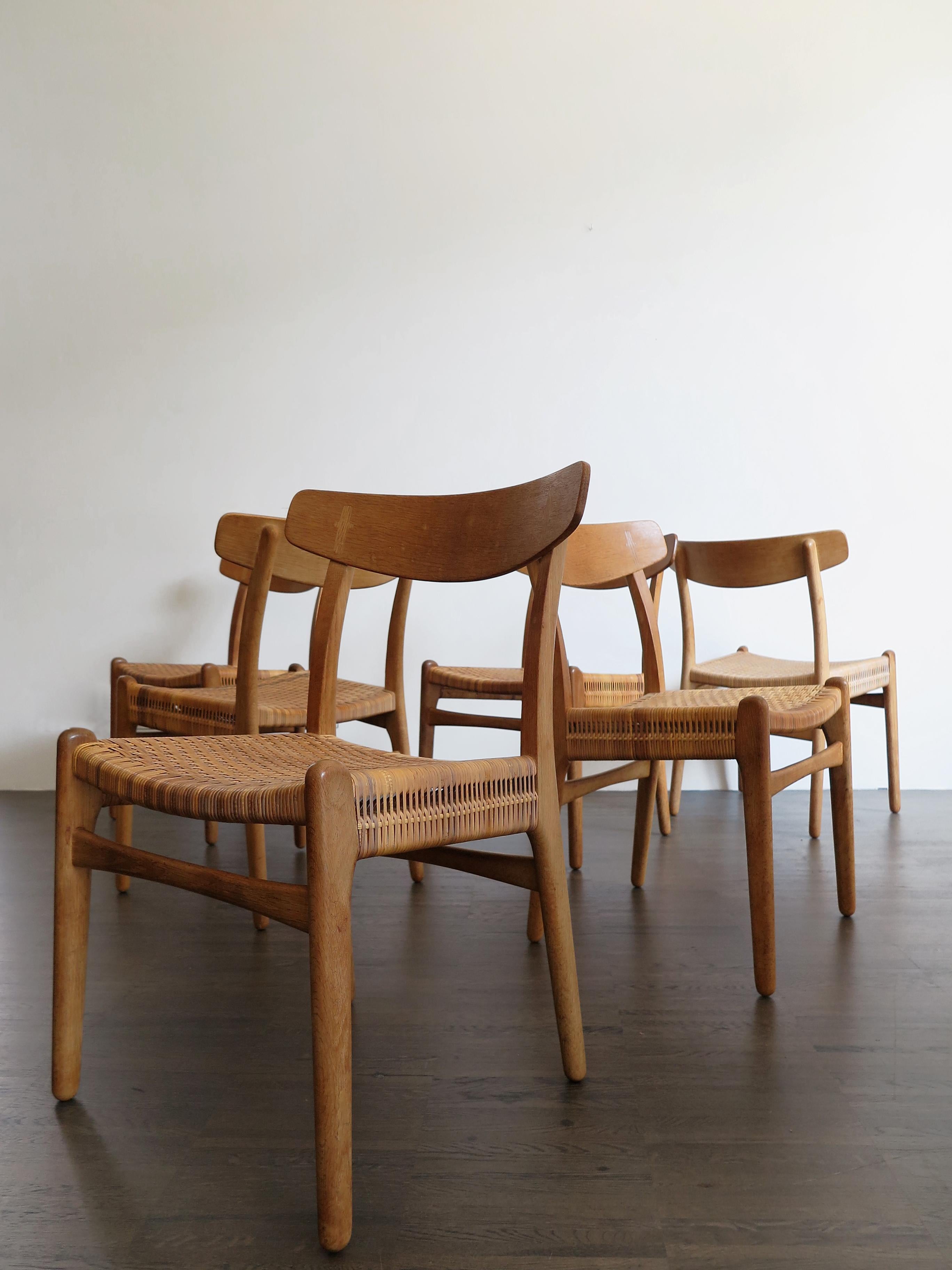 Set of six Scandinavian Mid-Century Modern design original dining chirs model CH23 designed by Hans Wegner and produced by Carl Hansen & Soon in Odense, rare model with oak and teak structure and original braid ratan cane, Denmark