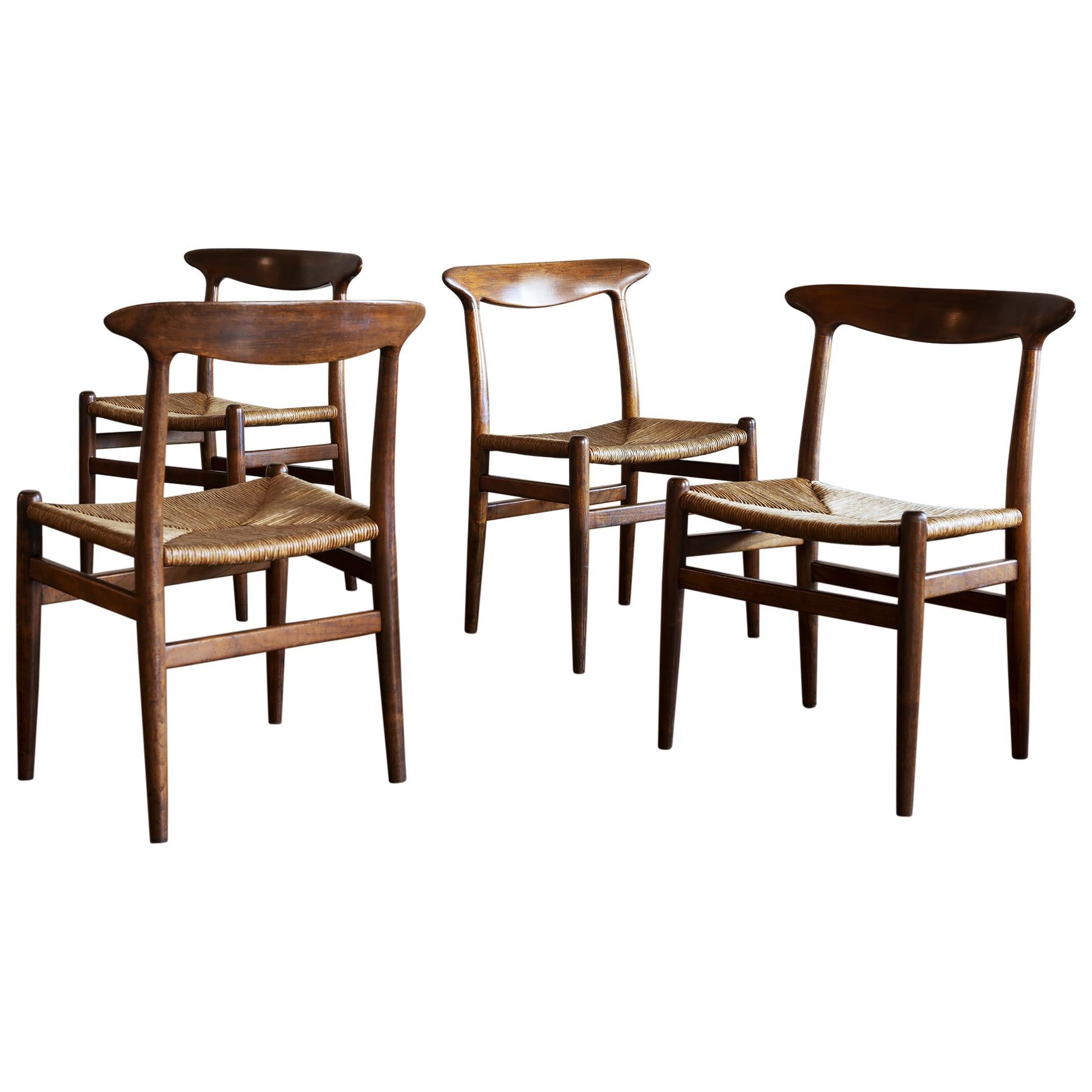 Hans Wegner Set of Four Model W2 Dining Chairs in Oak, Denmark, 1950s