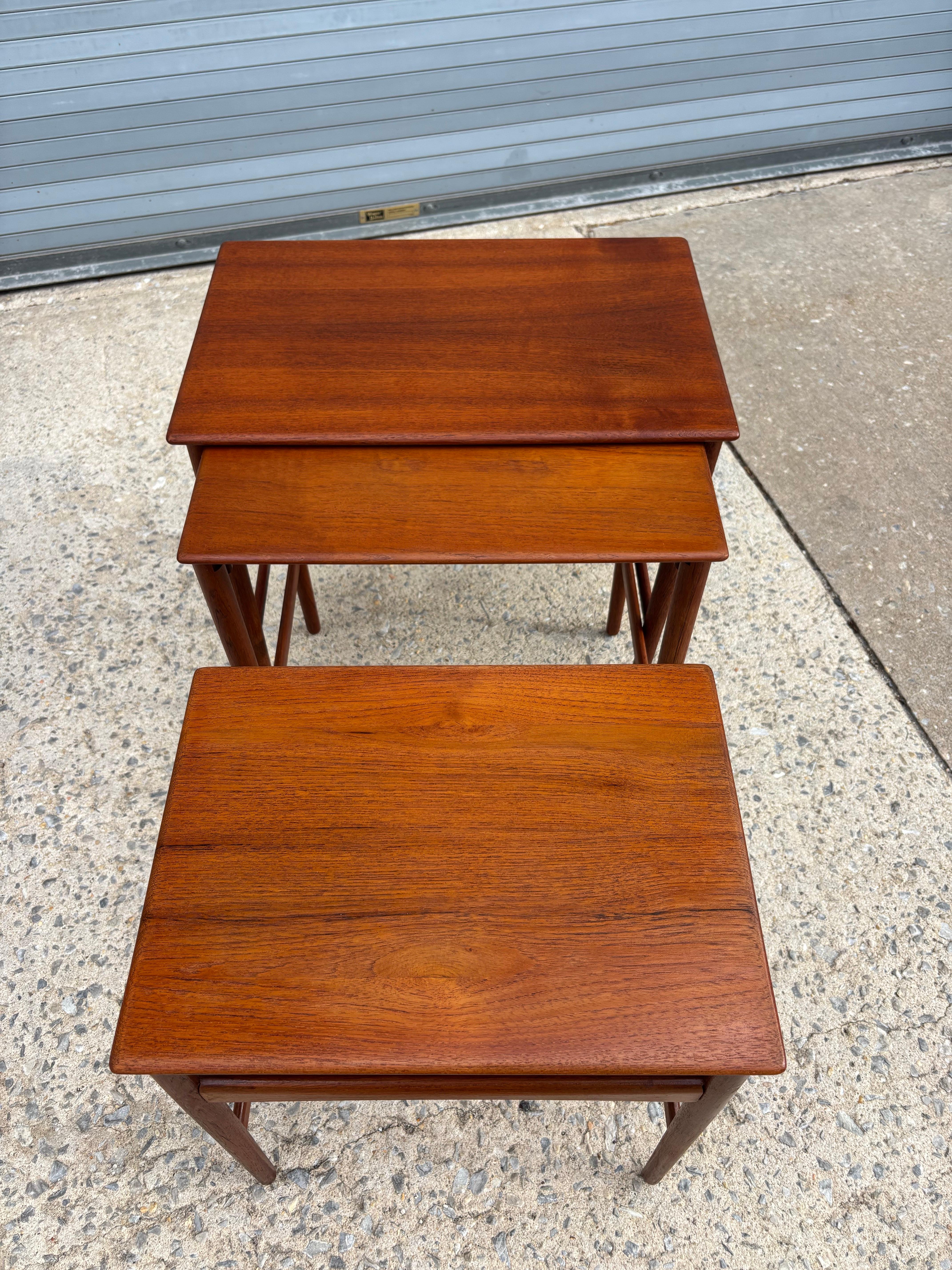 Hans Wegner Set of three teak nesting tables. Ideal size, tables slide together easily and take up very little room but when needed you can slide out second and third table.  Tops have been refinished and frames re-glued!  Sturdy little hard-working