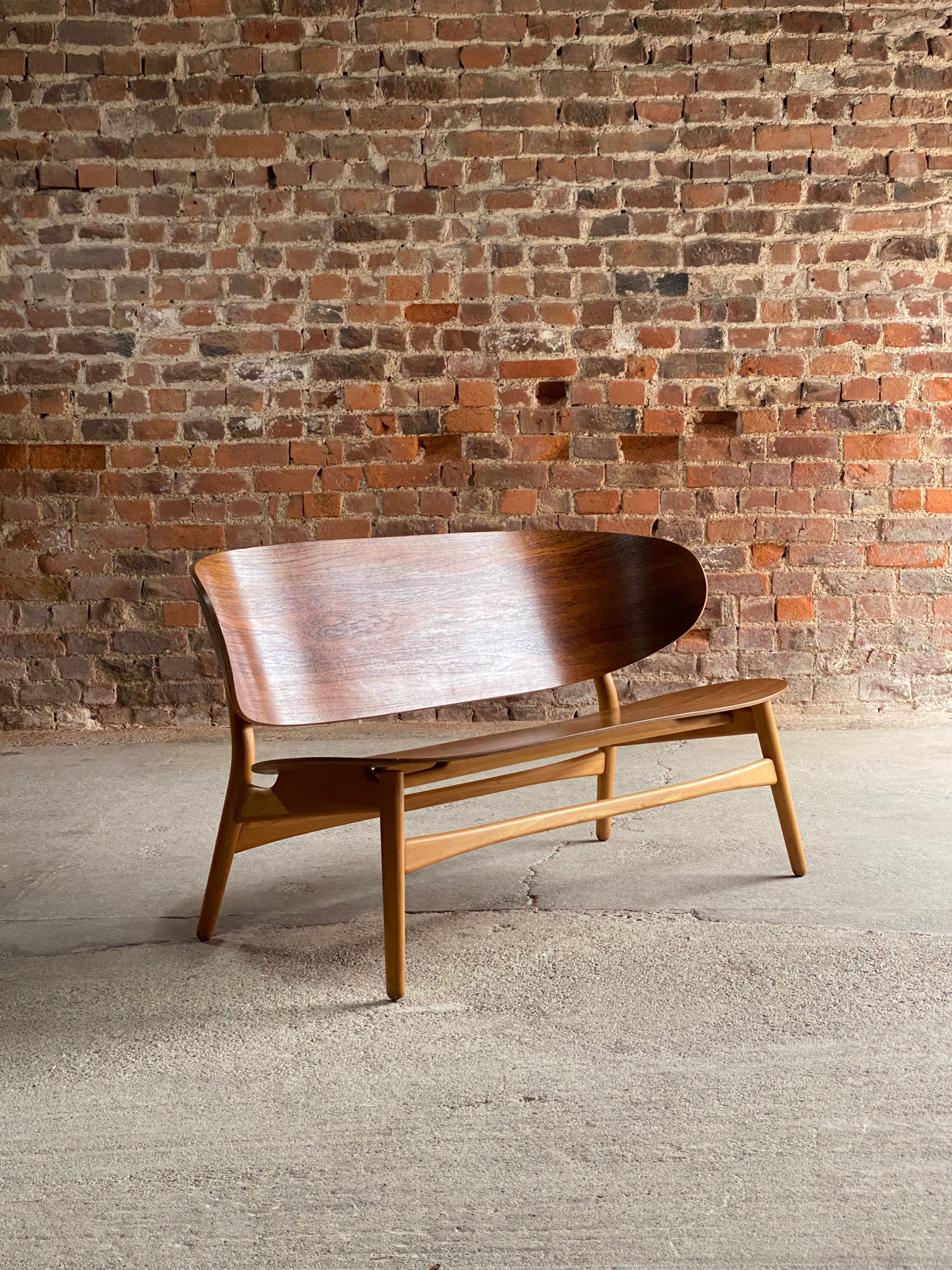 Hans Wegner shell settee Model 1935 by Fritz Hansen Denmark 1950

Hans J Wegner shell settee Model 1935 by Fritz Hansen Denmark circa 1950, this extremely rare and coveted collectors piece features a laminated teak shell back and seat, raised on a