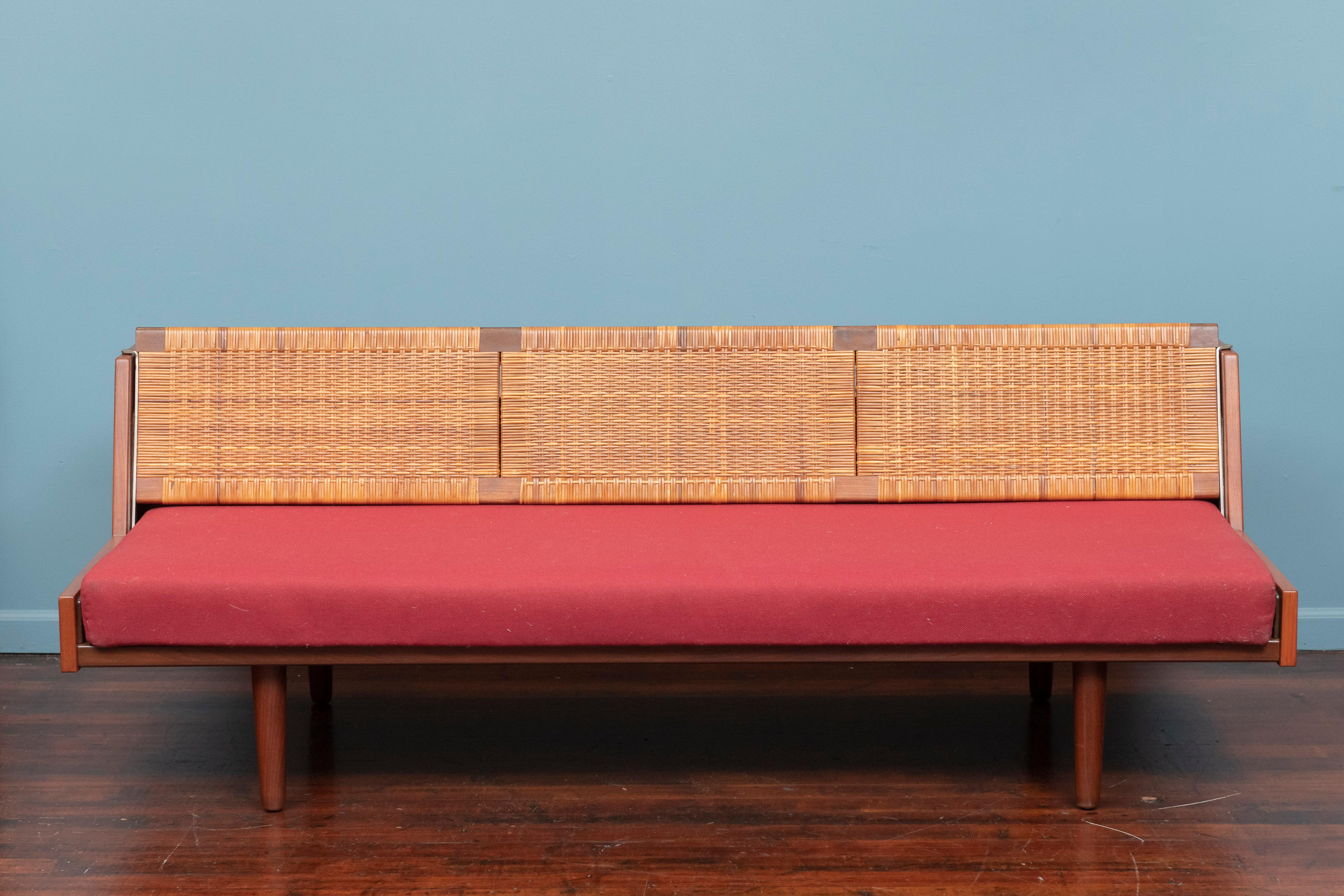 Sofá o sofá cama de diseño Hans Wegner para GETAMA, Dinamarca. Cabecero de caña restaurado y marco de teca repintado, conserva el colchón original en buen estado. Conversión inteligente de sofá a cama individual levantando y bloqueando el cabecero.