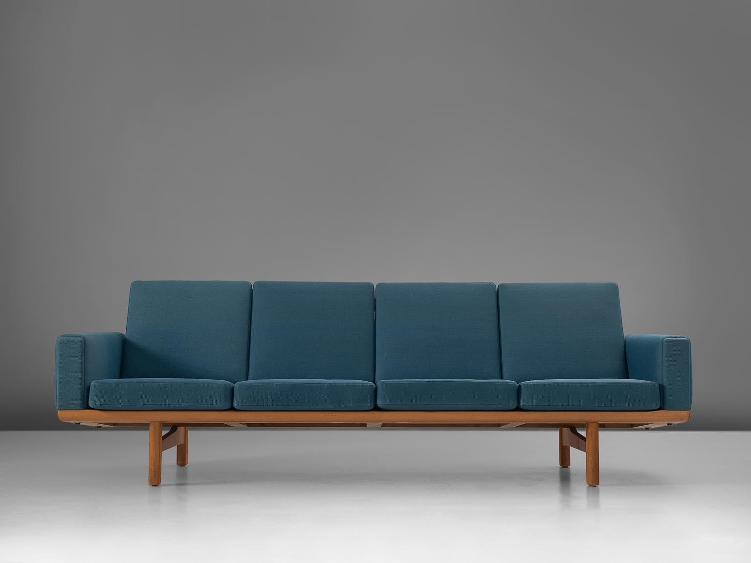 Sofa GE236/4, in oak and fabric, by Hans Wegner for GETAMA, Denmark, 1950s. 

Sofa designed by Hans Wegner for GETAMA. This sofa has a solid oak frame with real nice construction details. Due to the high legs and the low but detailed back, this