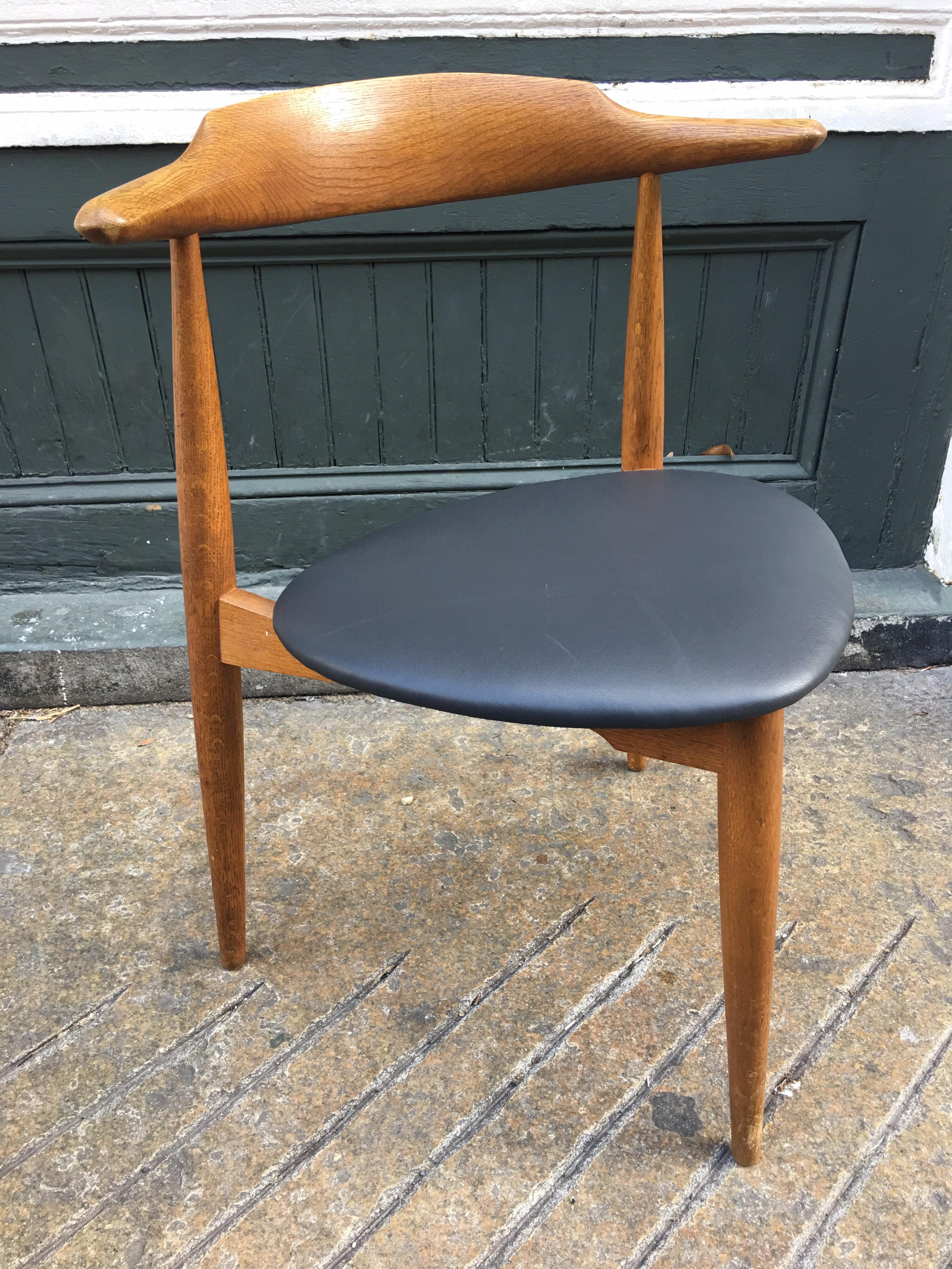 Nice pair of Hans Wegner stacking heart chairs for Fritz Hansen Furniture. New chocolate leather seat pads make these chairs ready to go! Fumed oak frames, classic 3-legged design.  
SOLD AS A PAIR!