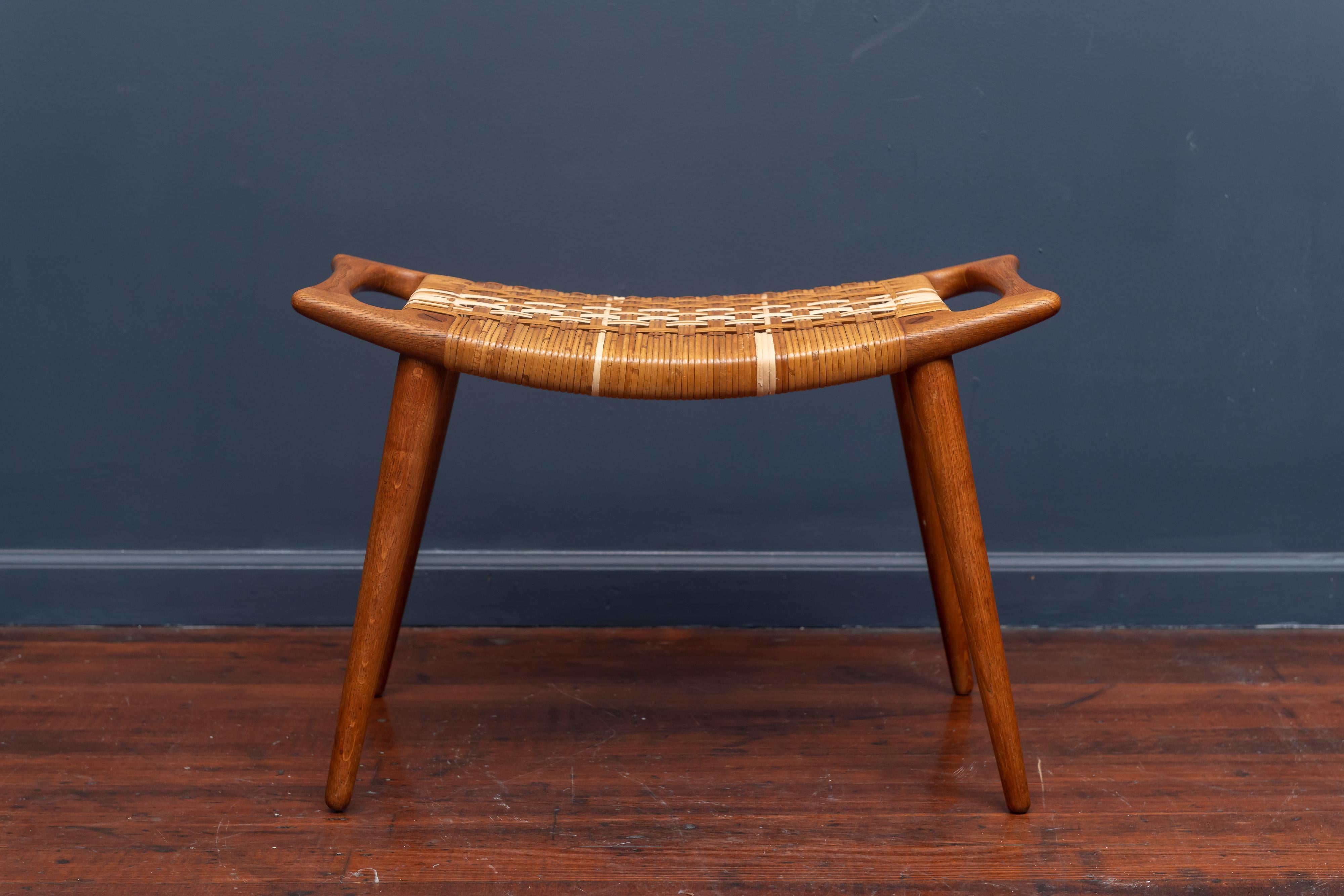 Hans Wegner teak and cane stool or bench for Johannes Hanse, Denmark. Restored caning which color match over time.